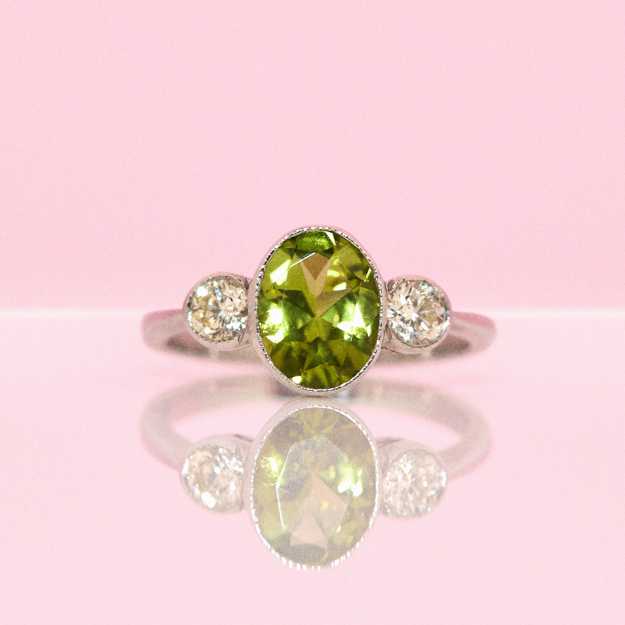 Platinum peridot and diamond three stone ring