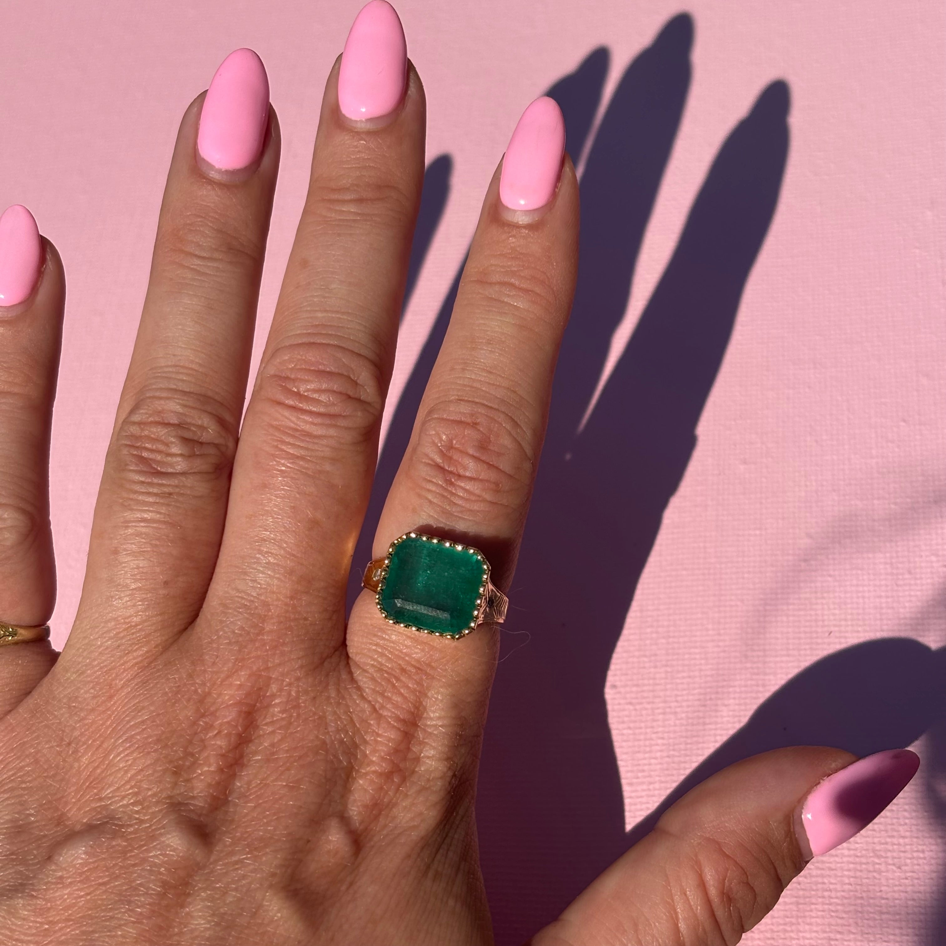 14ct gold 10.80ct Asscher cut emerald and diamond ring with engraved shoulders