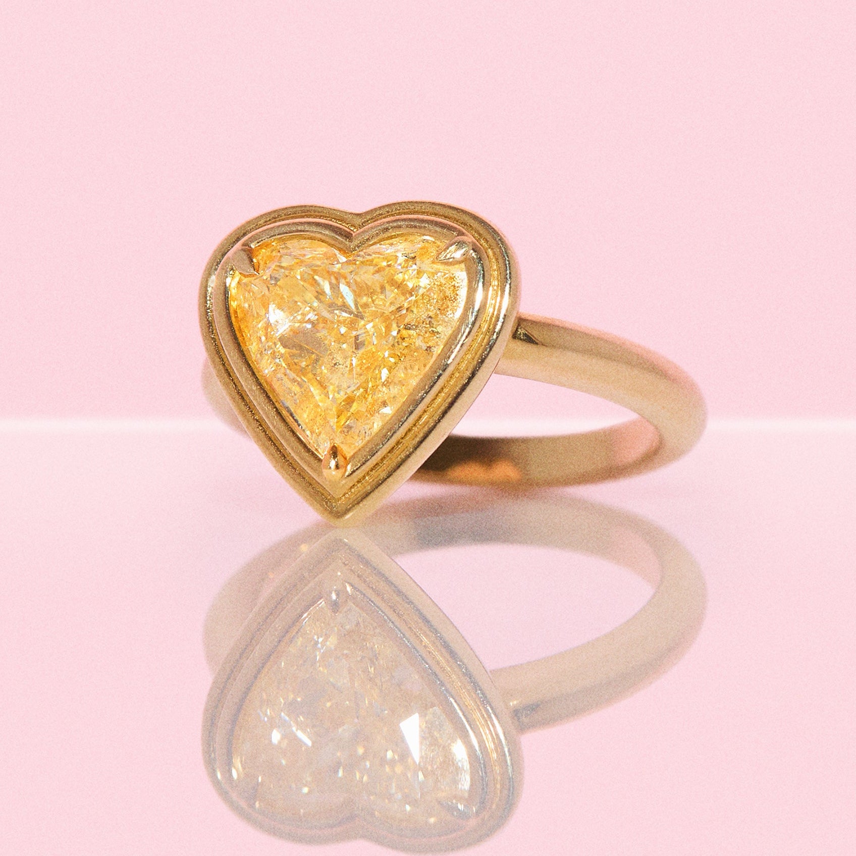 18ct gold bezel set fancy yellow 2.35ct heart-shaped diamond ring