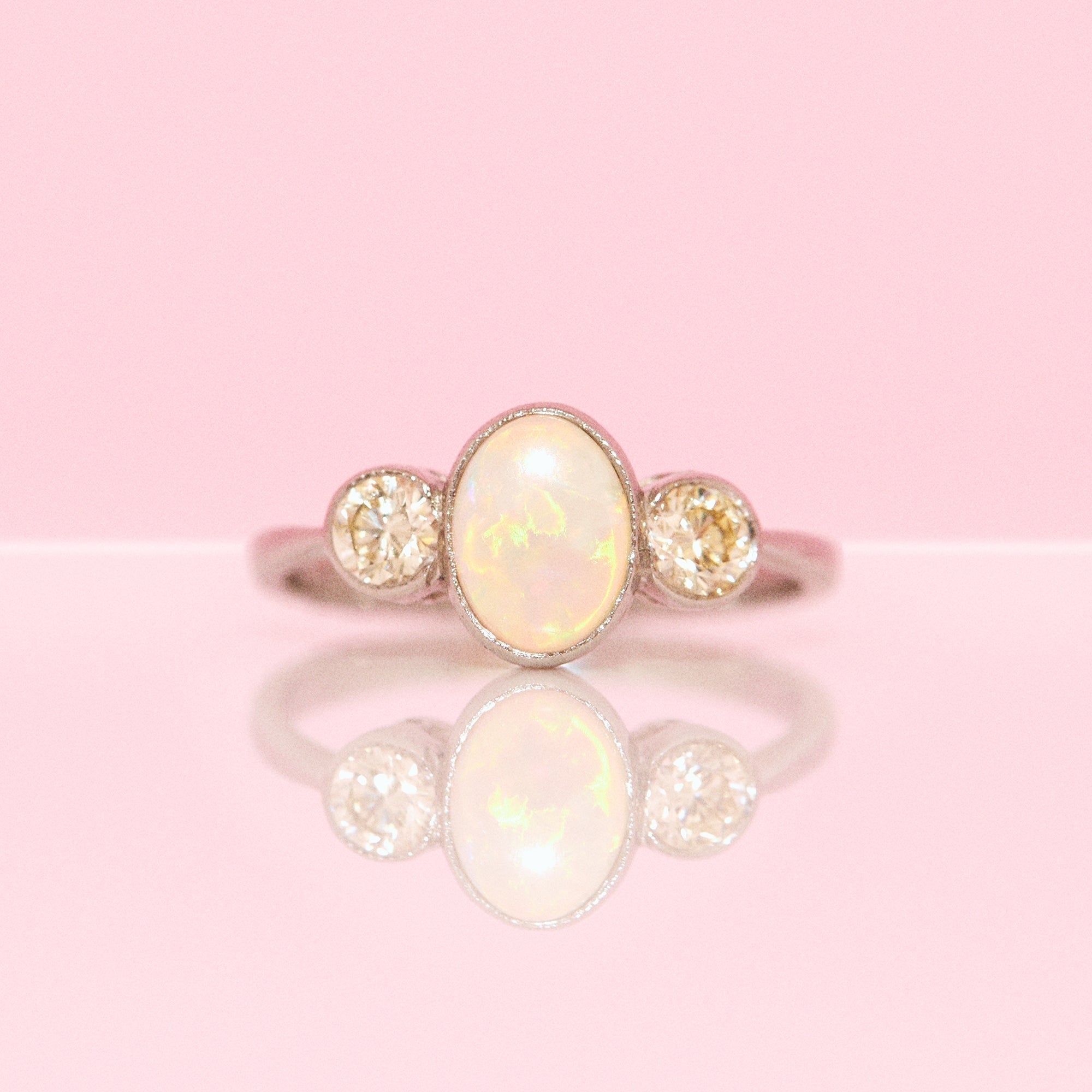 Platinum opal and diamond three stone ring