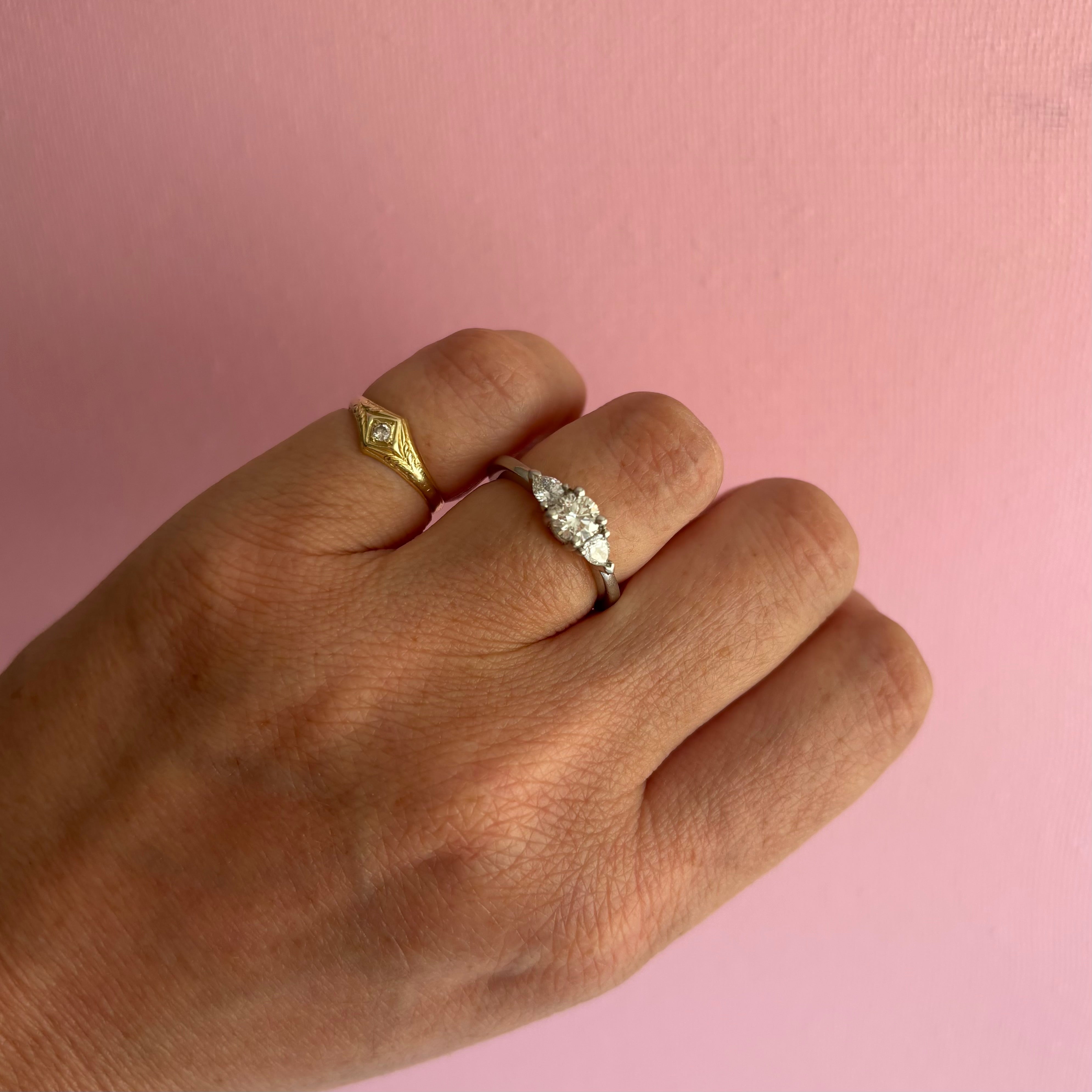 Platinum three stone tier drop diamond ring