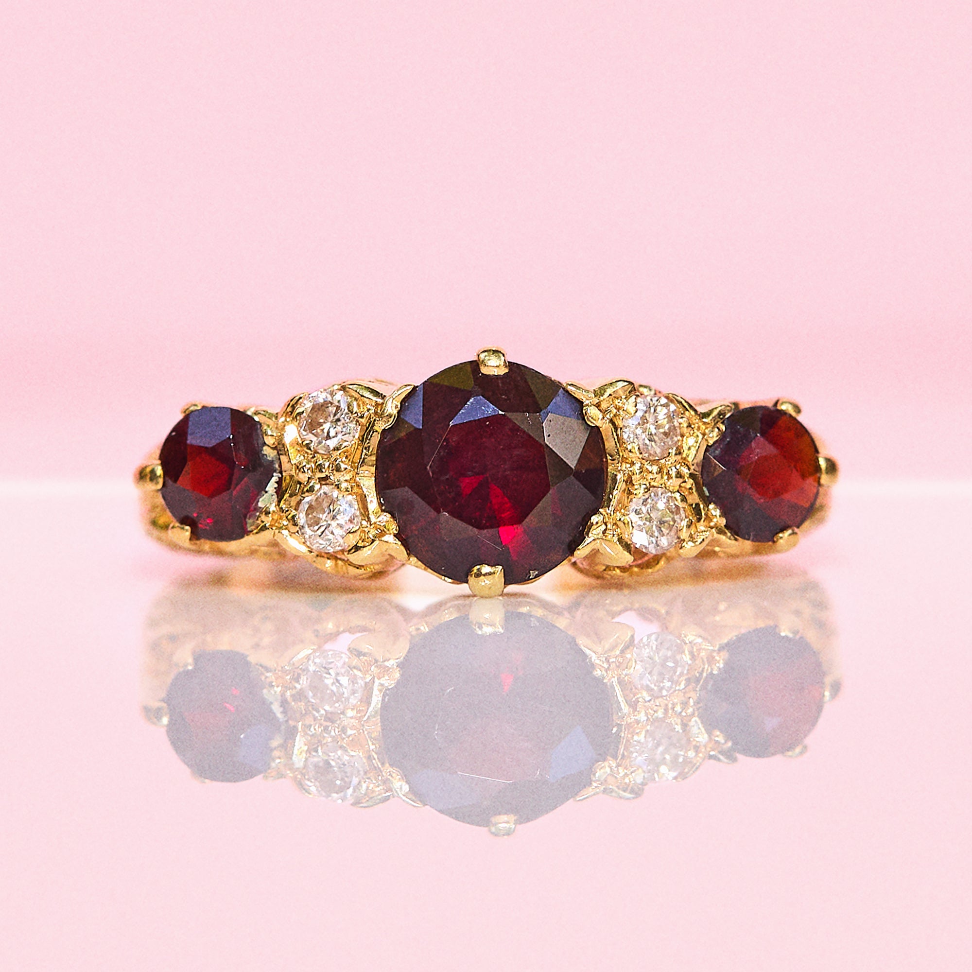 18ct gold garnet and diamond seven stone ring