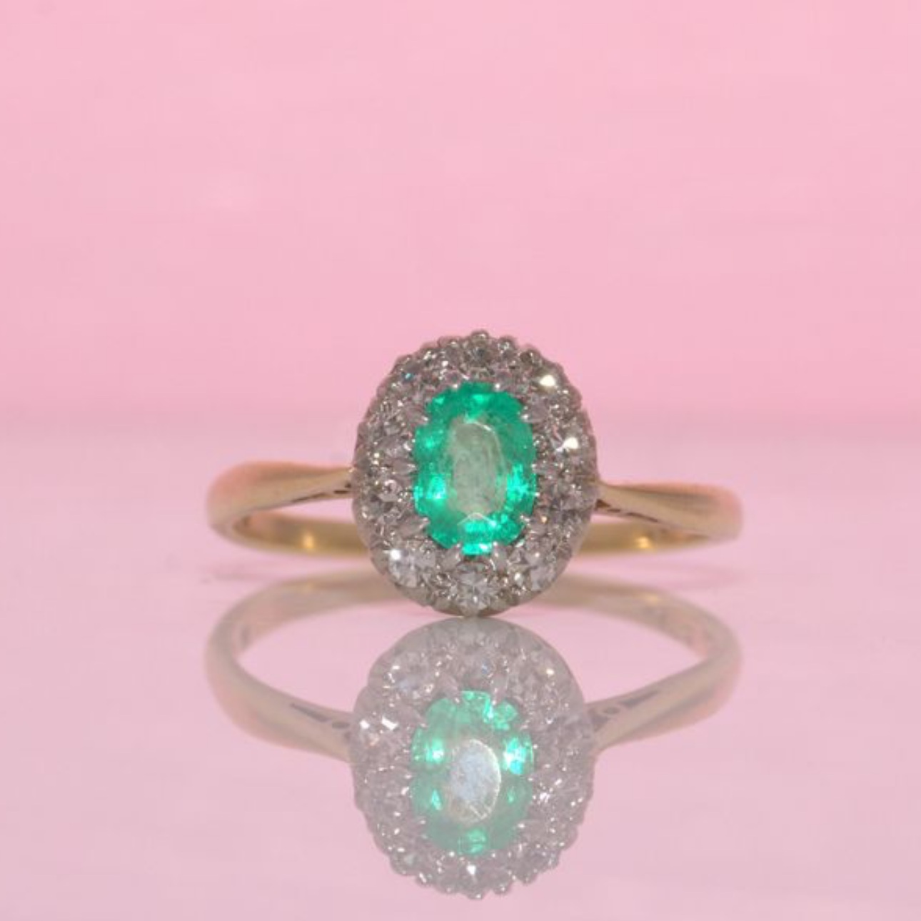 18ct gold oval emerald and diamond cluster ring
