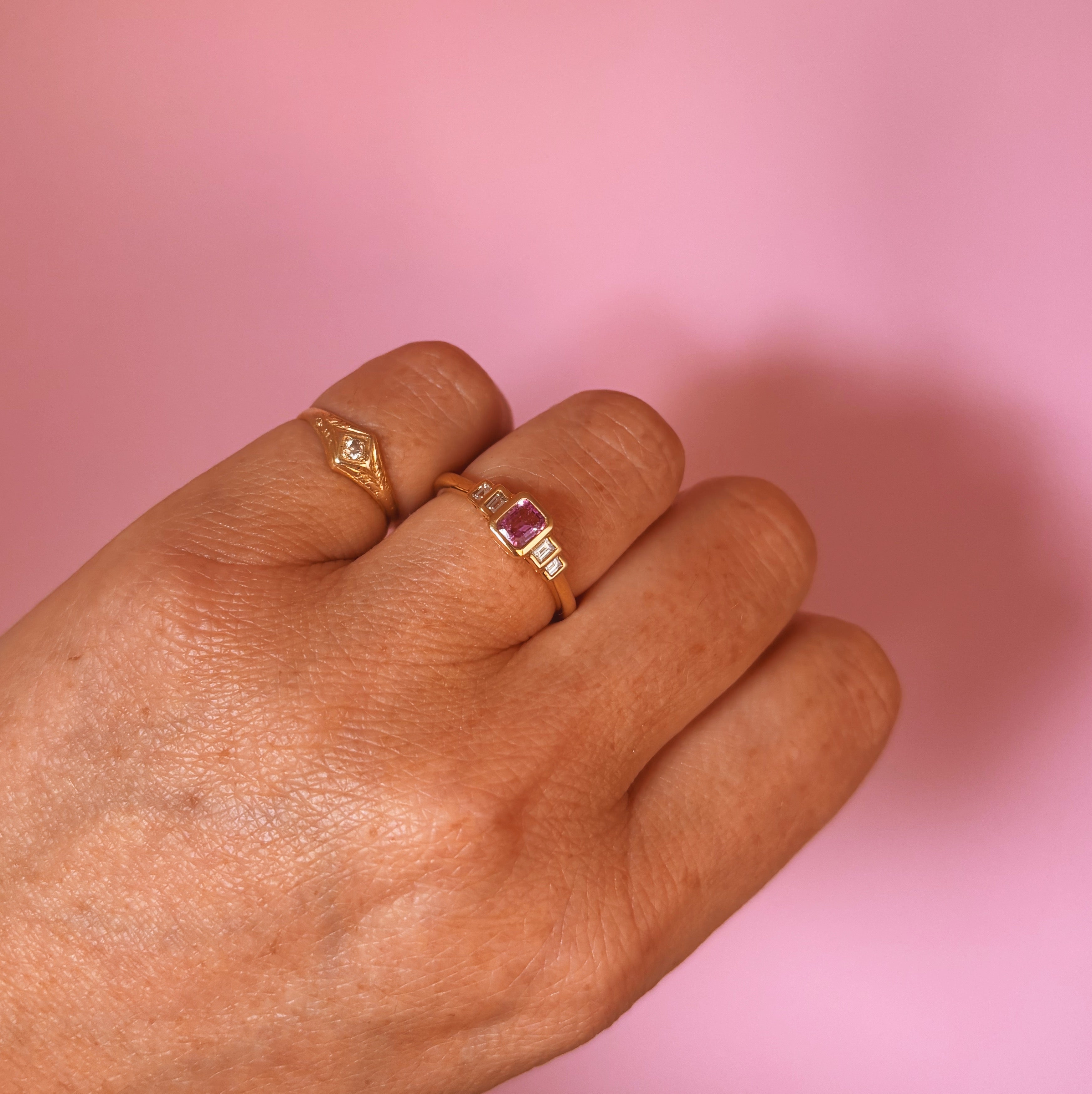 18ct gold 0.52ct emerald cut pink sapphire and baguette diamond three stone ring