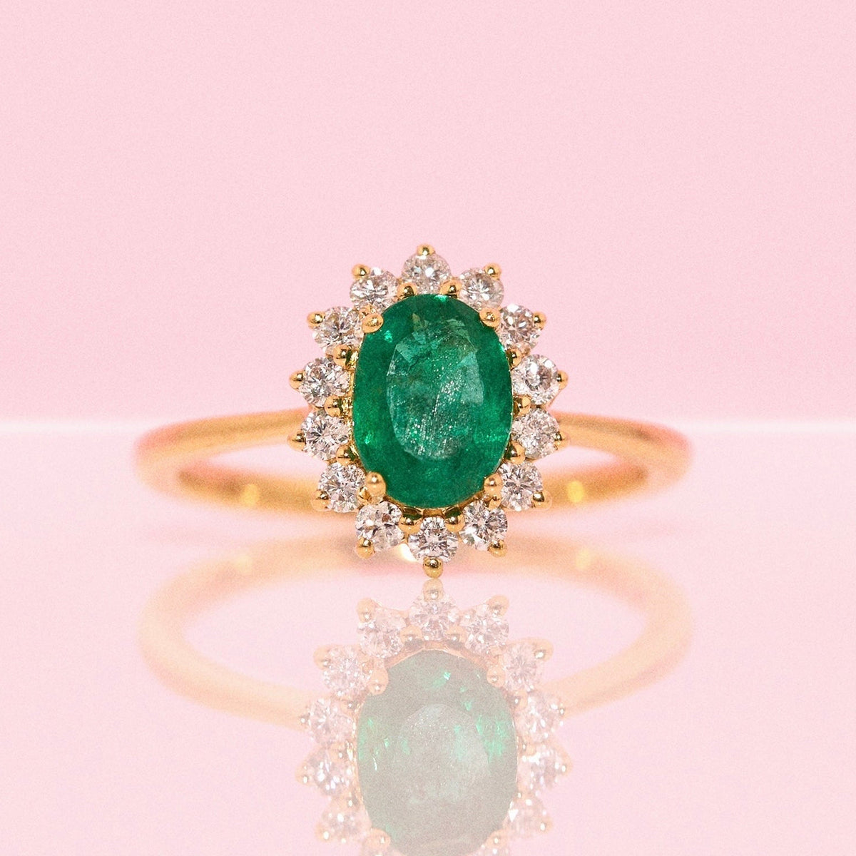 9ct gold 1.10ct oval emerald and 0.32ct diamond cluster ring
