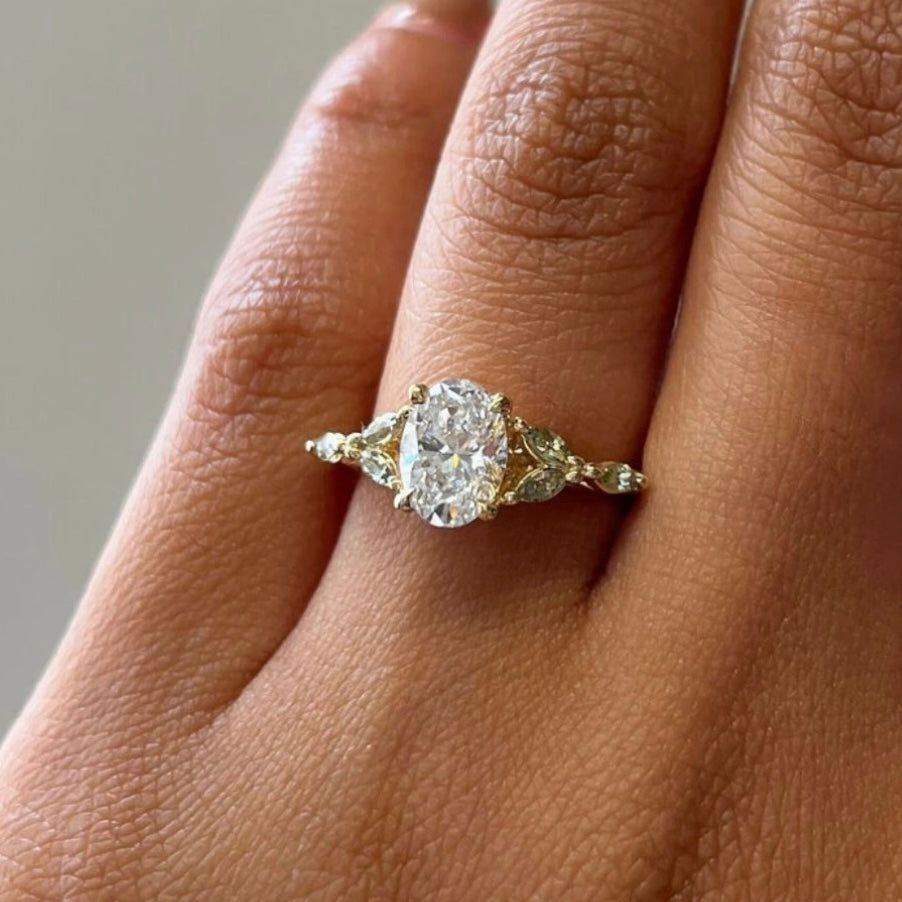 18ct gold 0.70ct oval diamond cluster ring