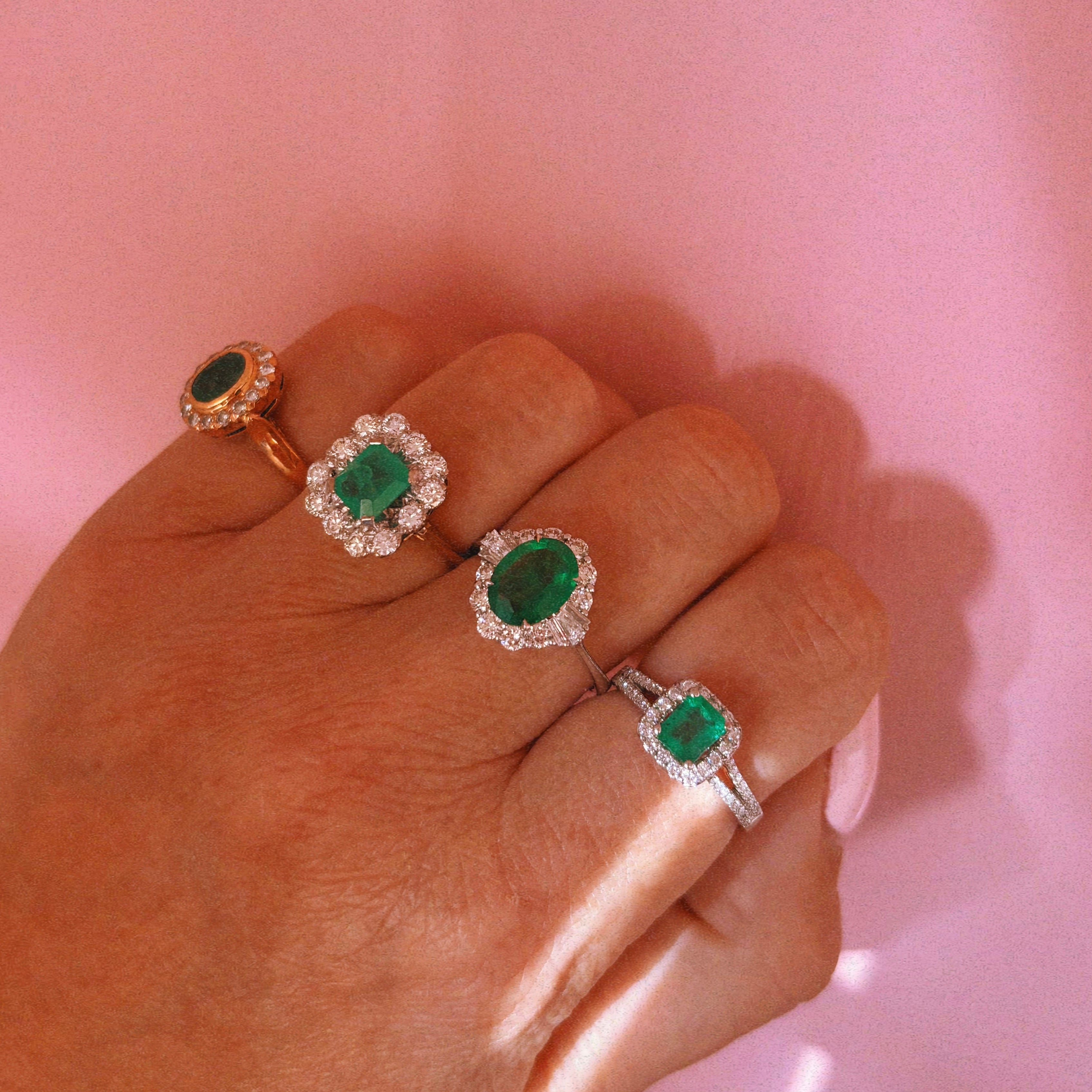 Platinum emerald cut emerald and diamond split shoulder ring