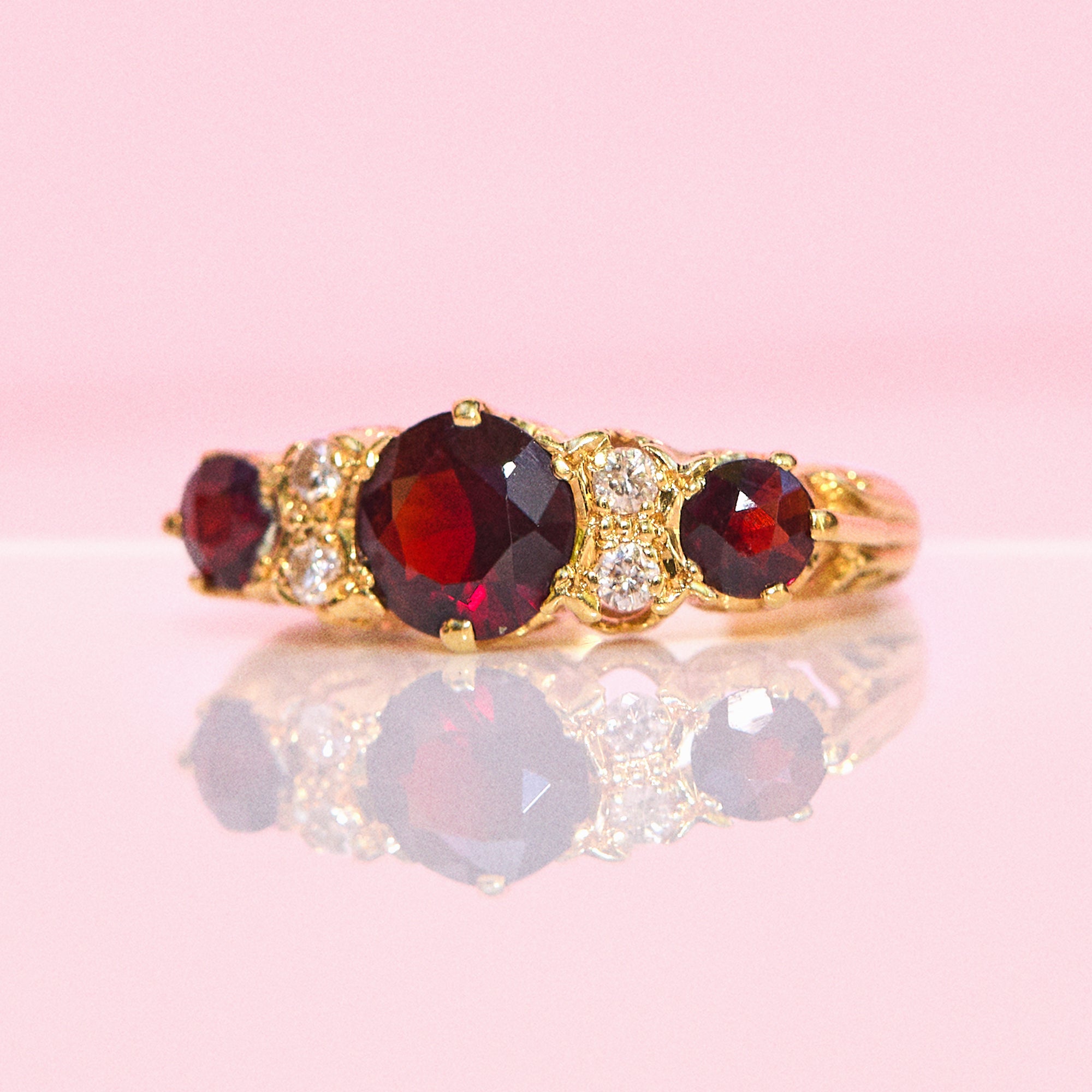 18ct gold garnet and diamond seven stone ring