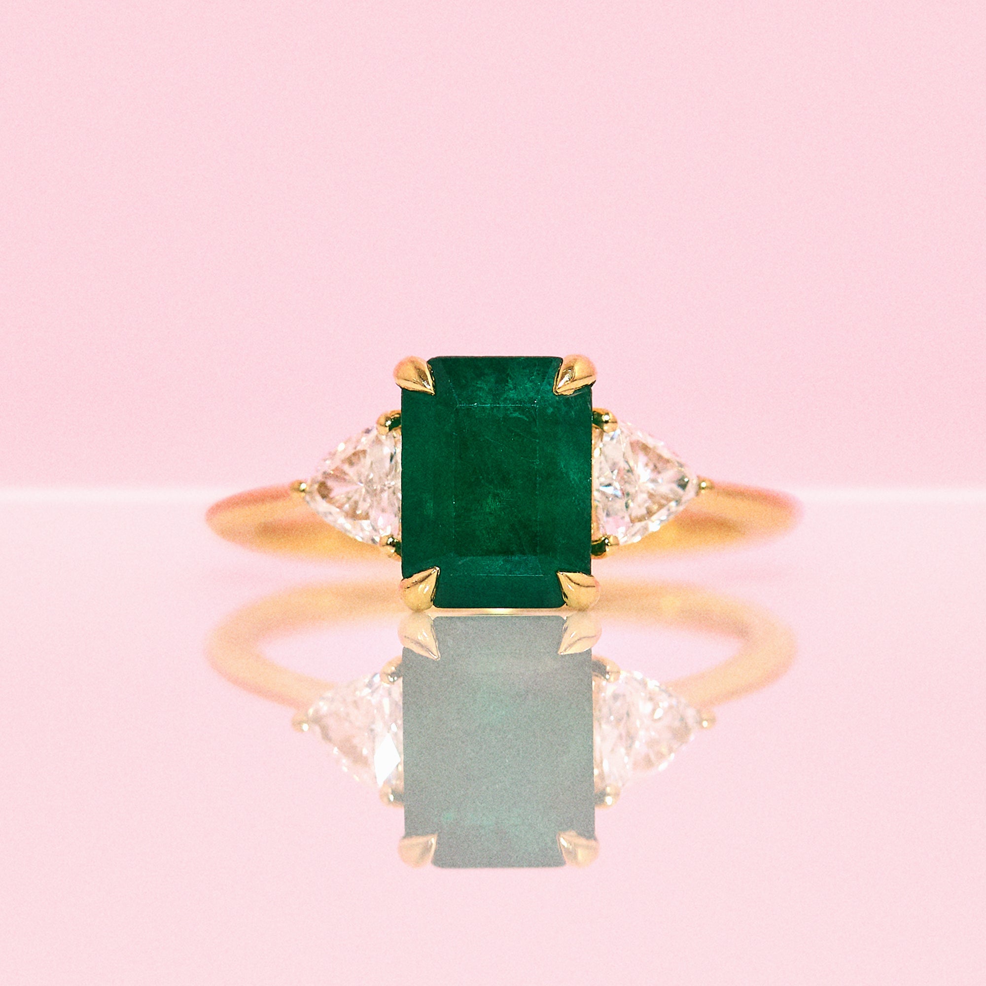 18ct gold emerald and diamond trillion three stone ring