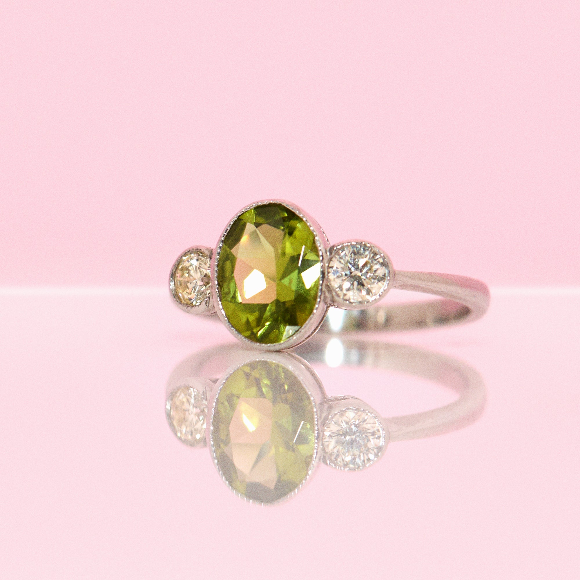 Platinum peridot and diamond three stone ring