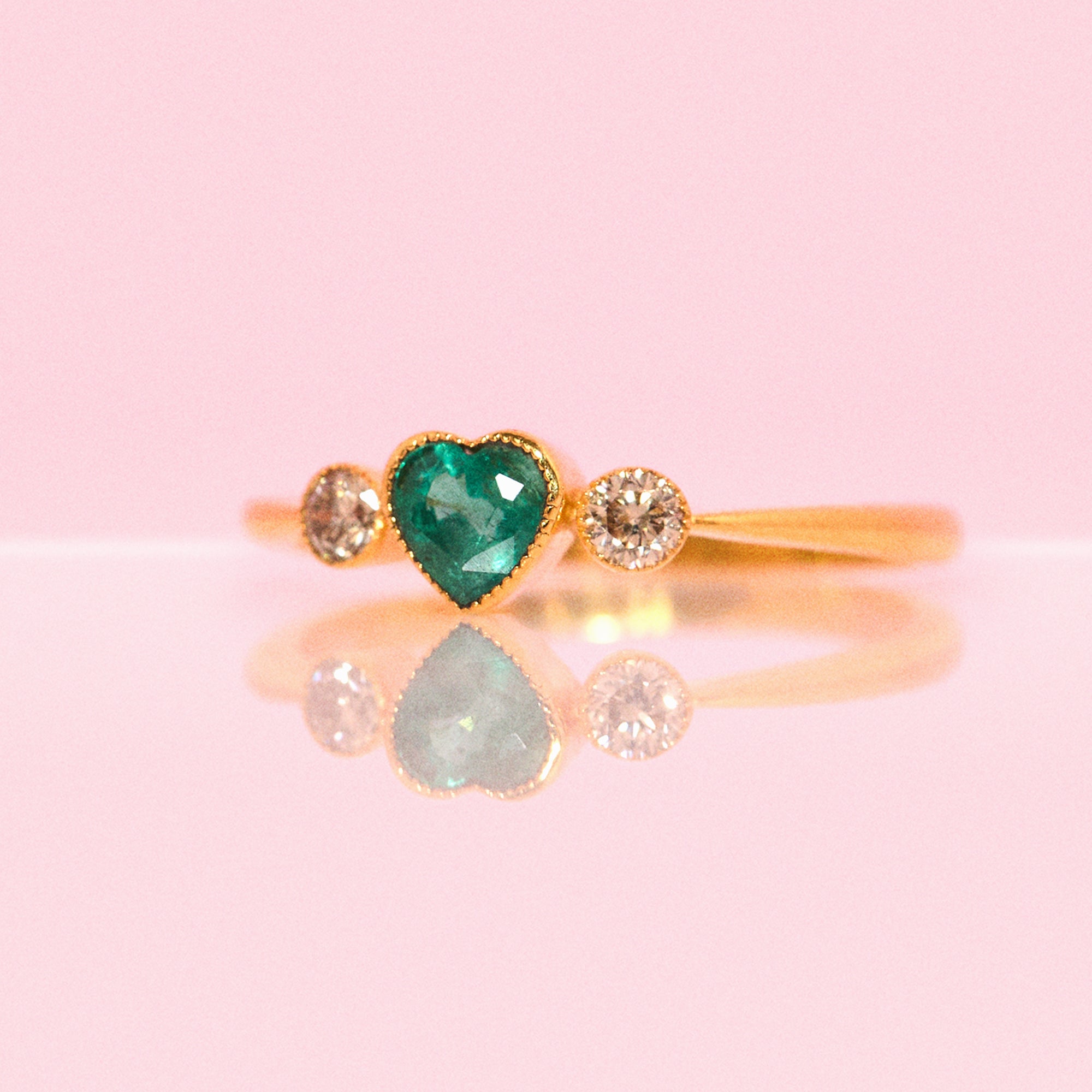 14ct gold heart-shaped emerald and diamond three stone ring