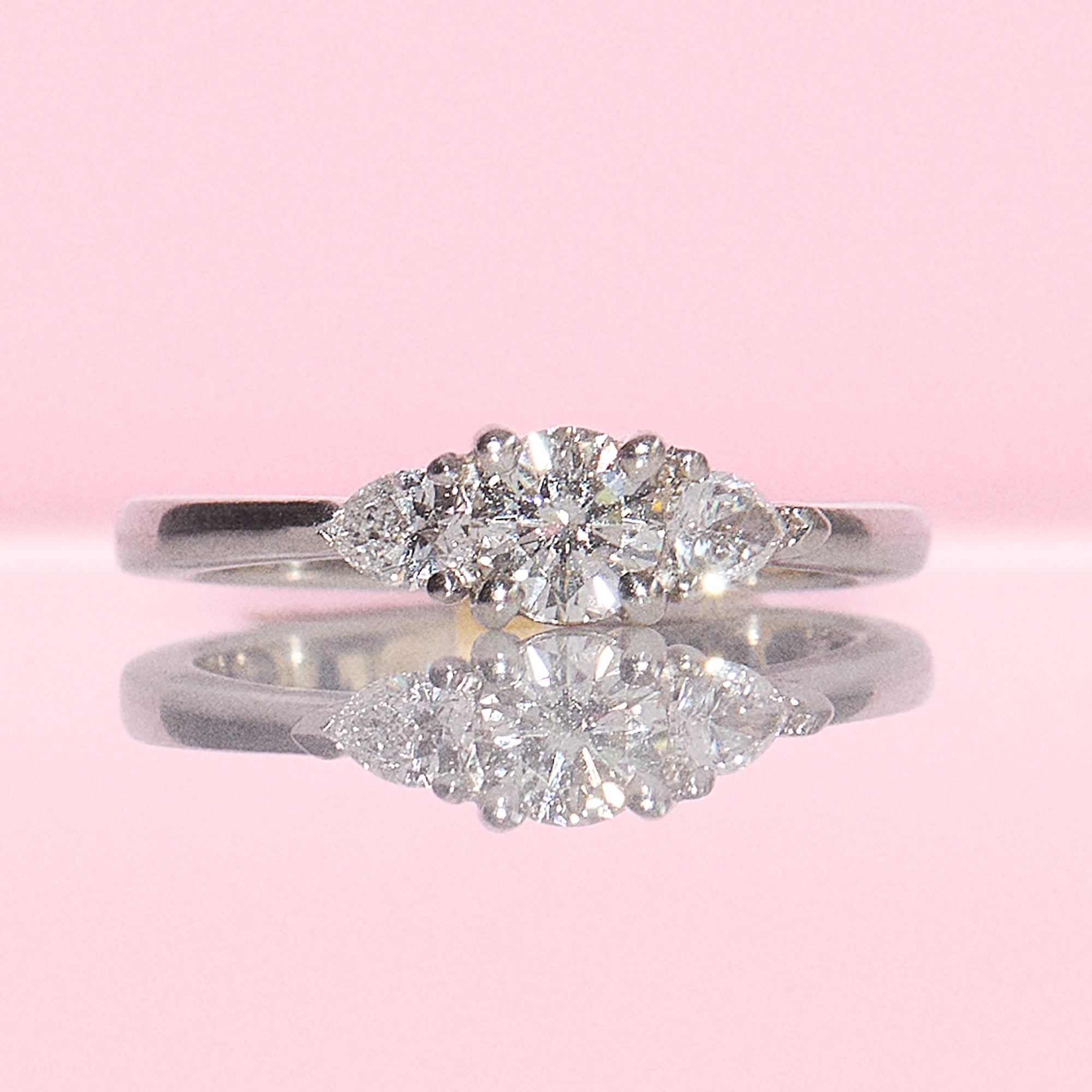 Platinum three stone tier drop diamond ring