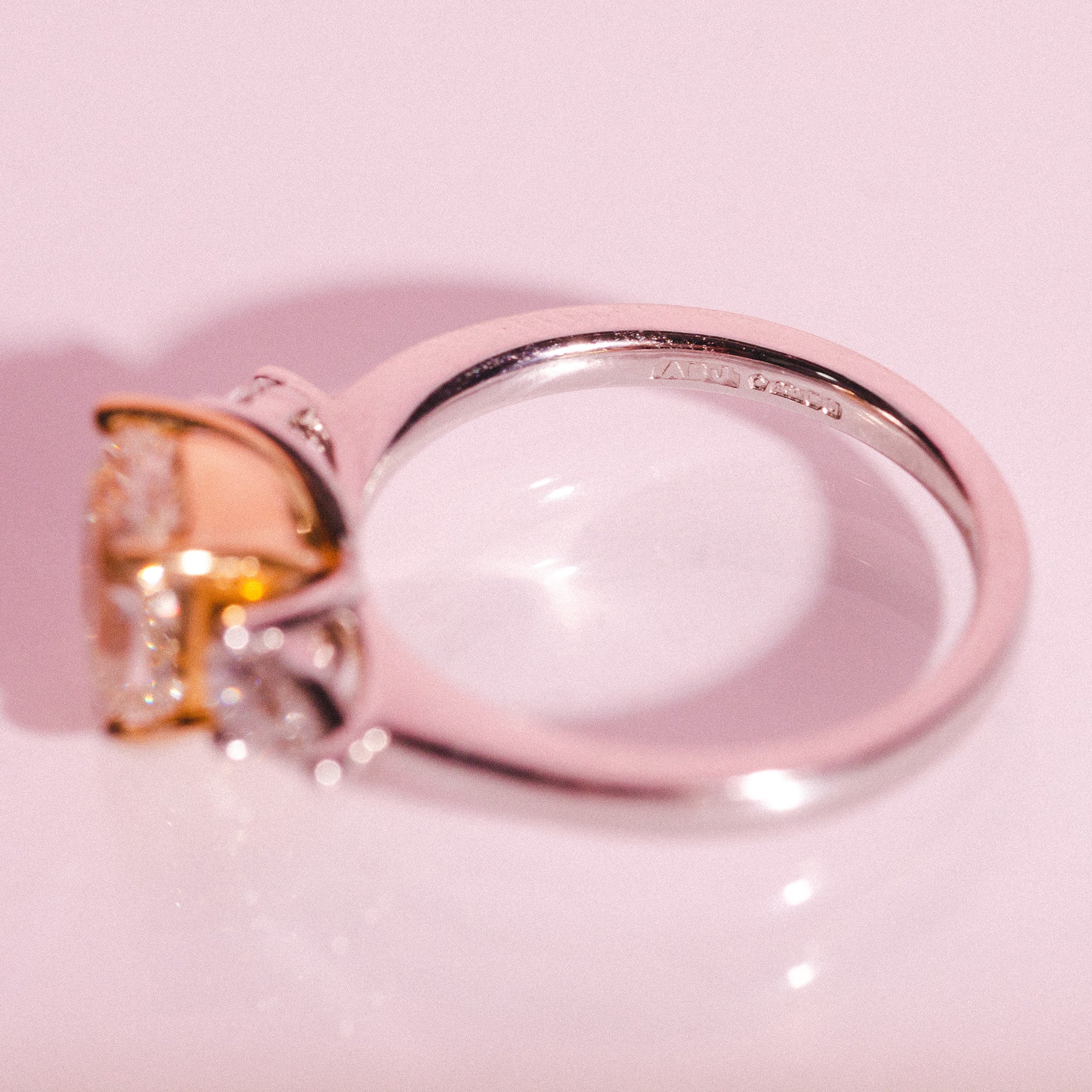Platinum ring set with one cushion cut yellow diamond and two pear shaped diamonds