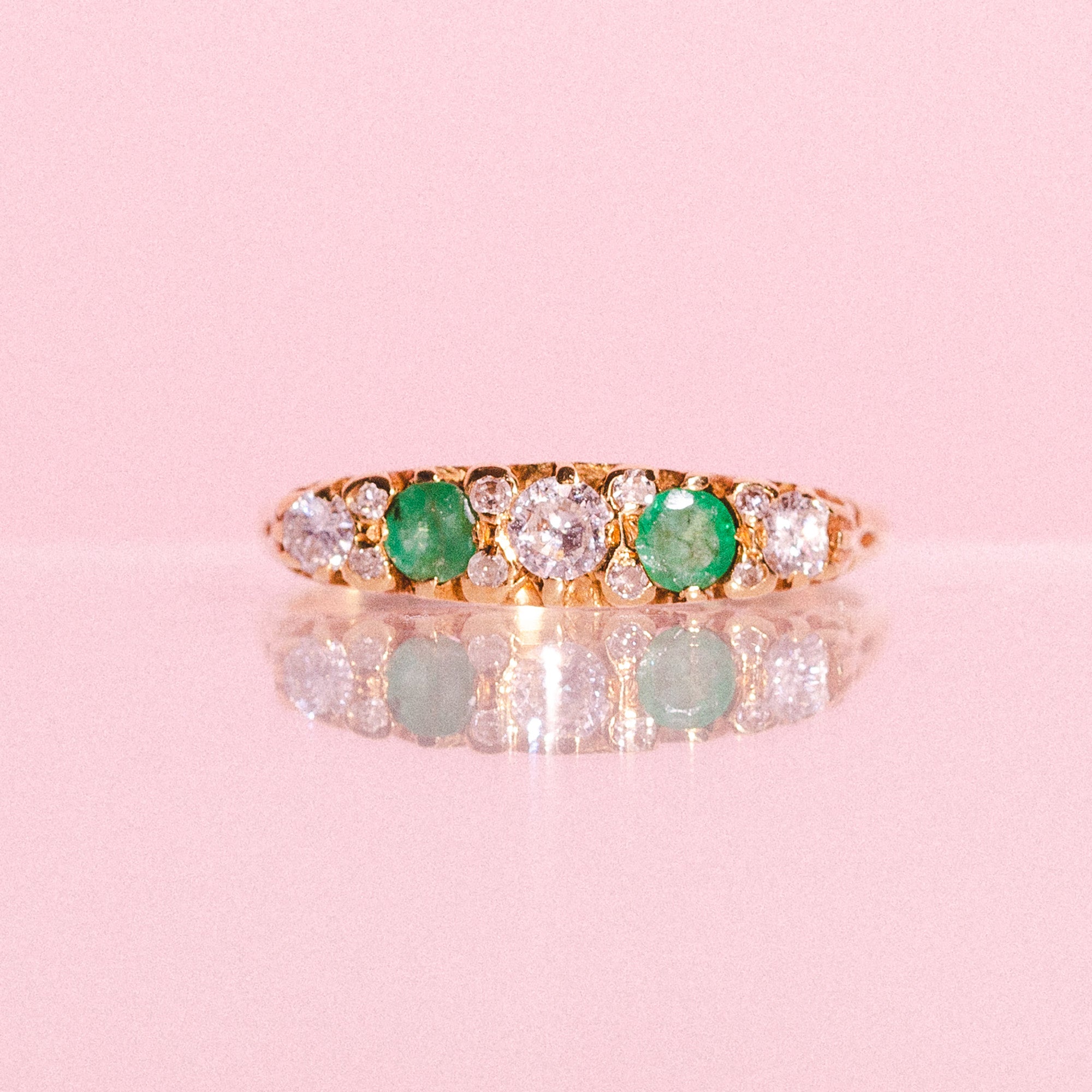 18ct gold ring set with emeralds and diamonds