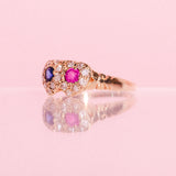18ct gold love ring set with a ruby, a sapphire and diamonds