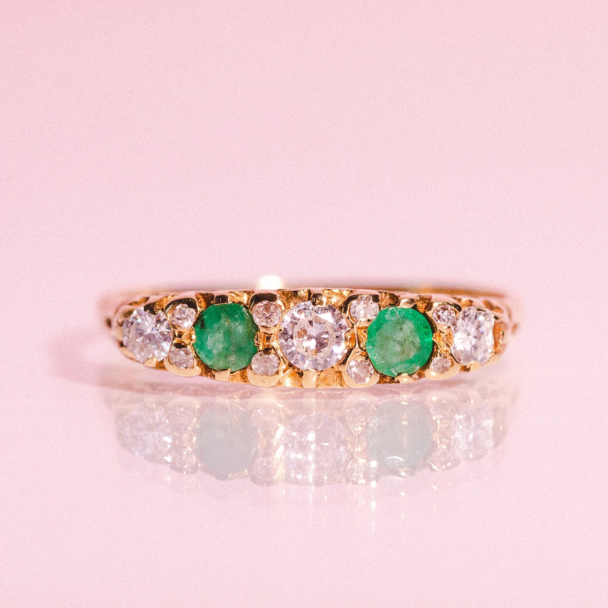 18ct gold ring set with emeralds and diamonds