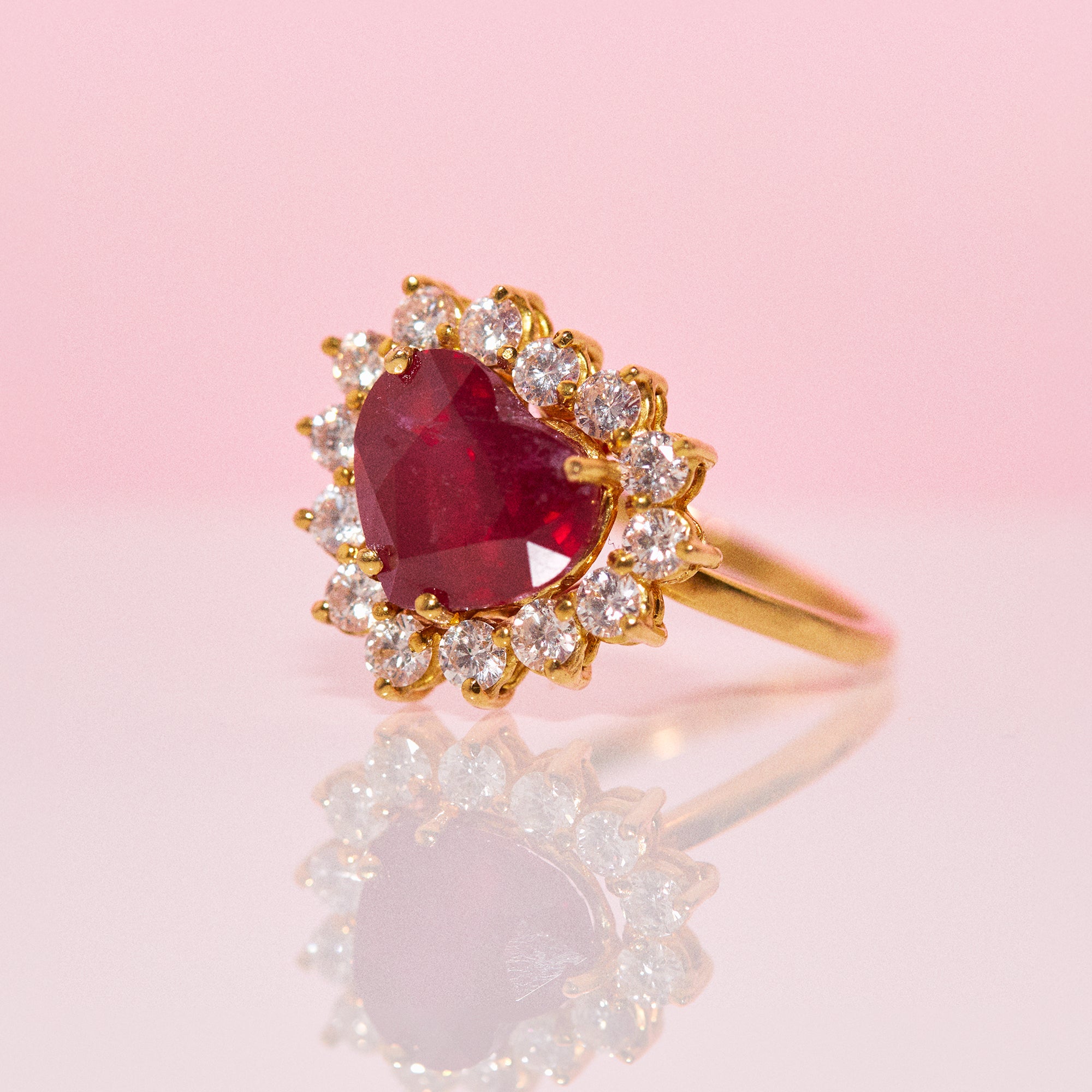 18ct gold ring set with a heart shaped ruby and diamonds