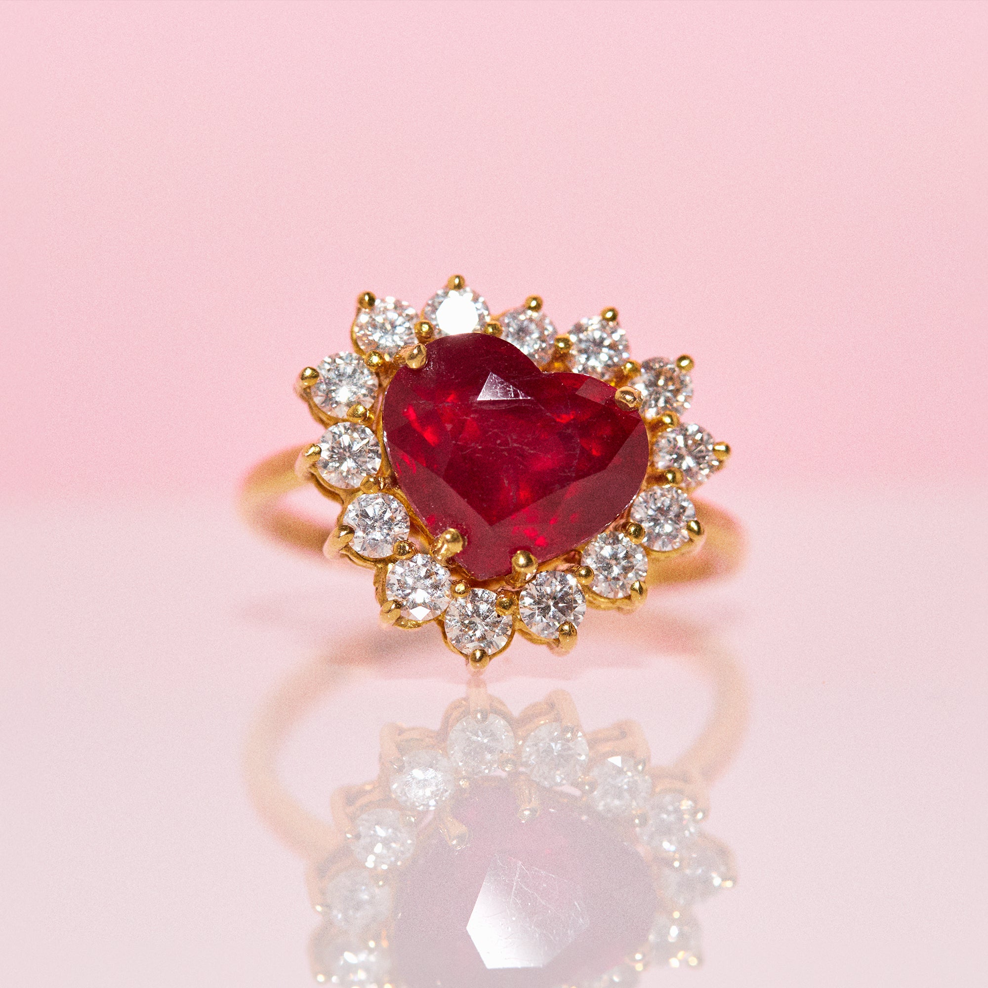 18ct gold ring set with a heart shaped ruby and diamonds