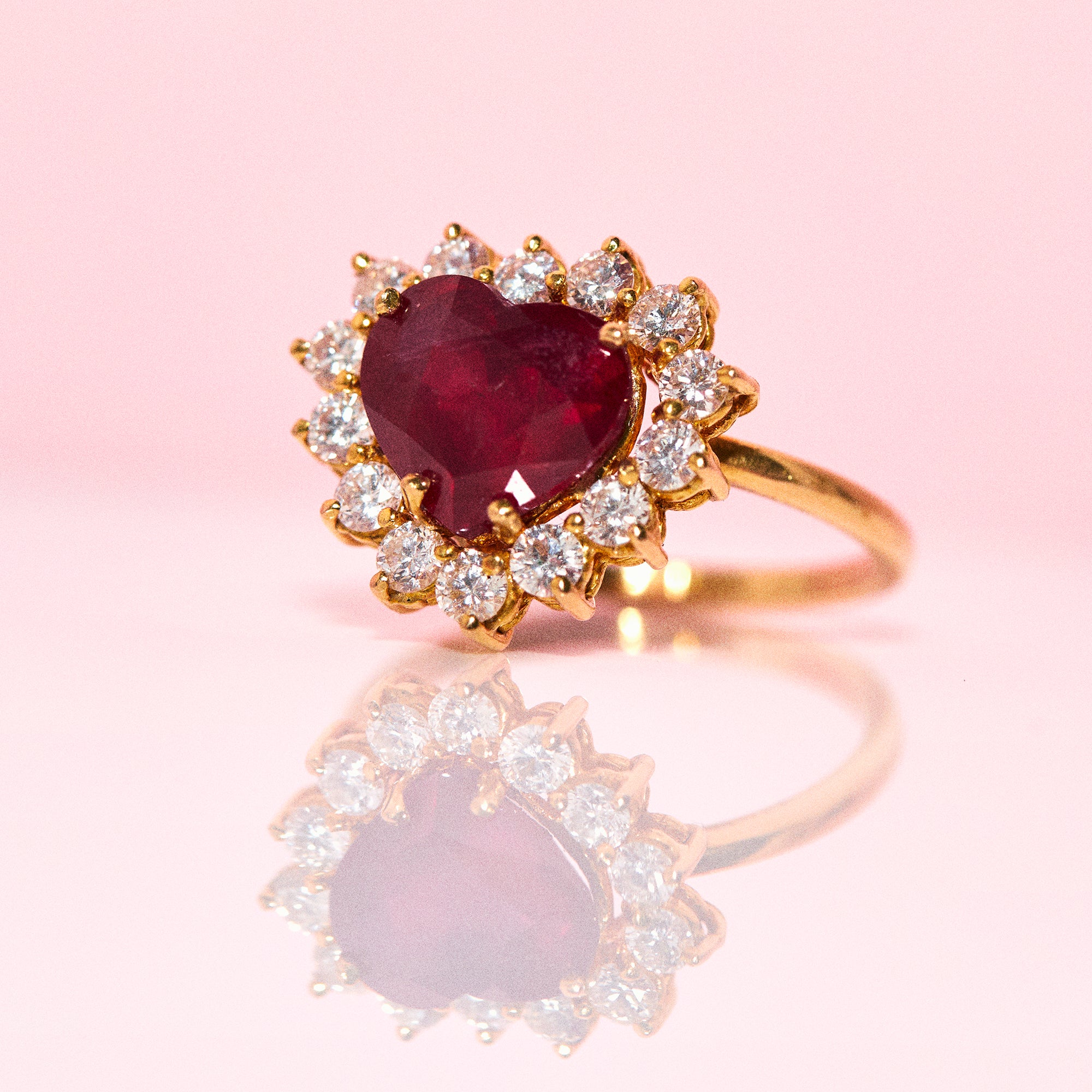 18ct gold ring set with a heart shaped ruby and diamonds