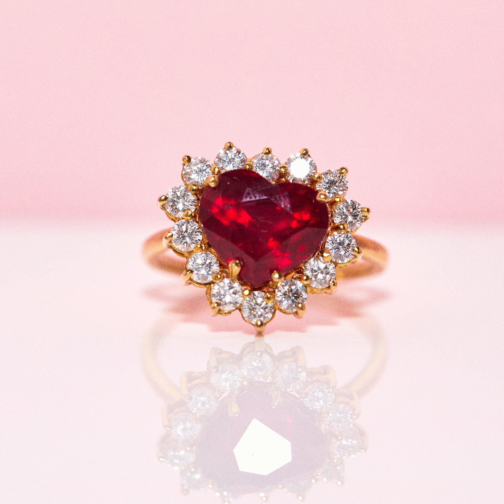 18ct gold ring set with a heart shaped ruby and diamonds