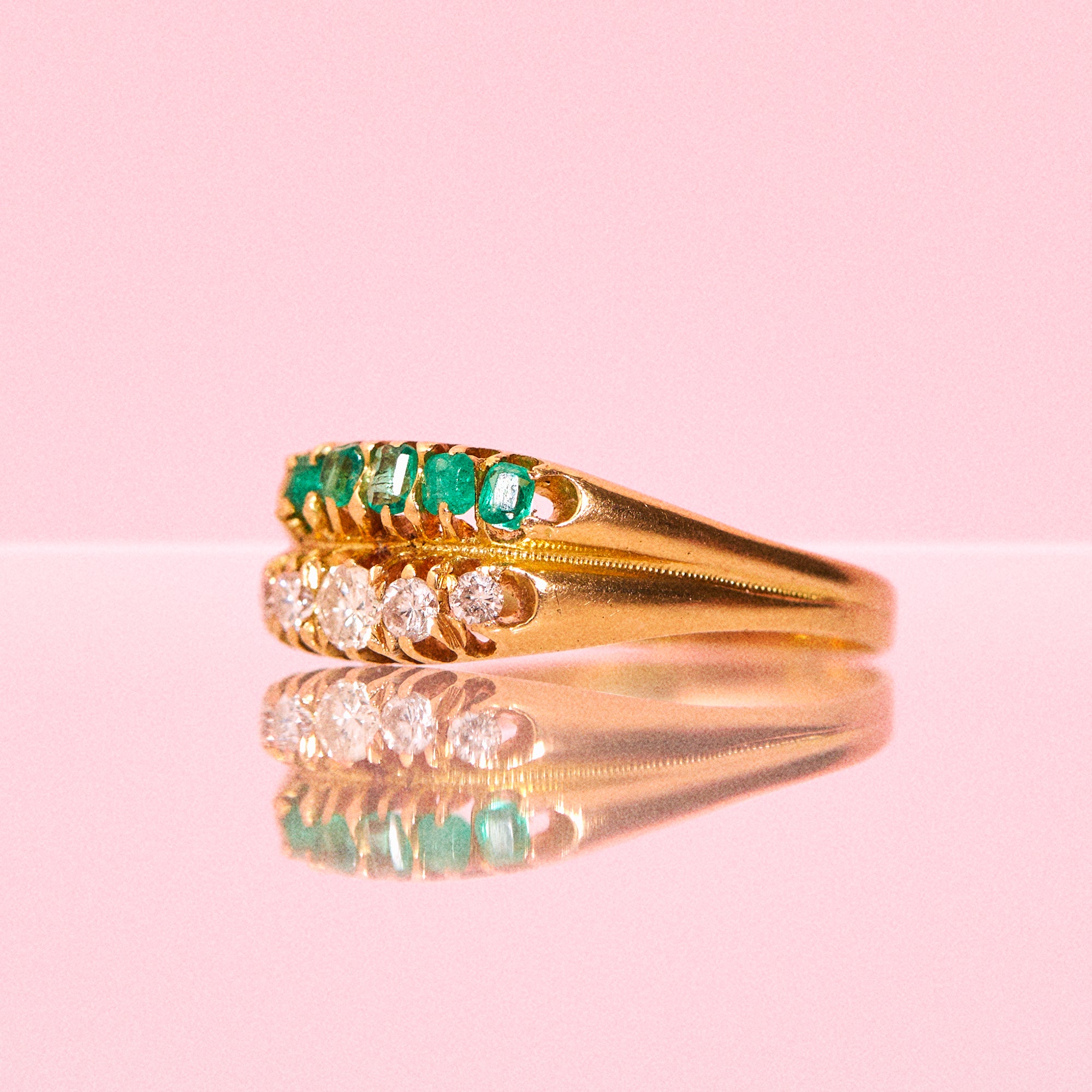 18ct gold ring set with emeralds and diamonds