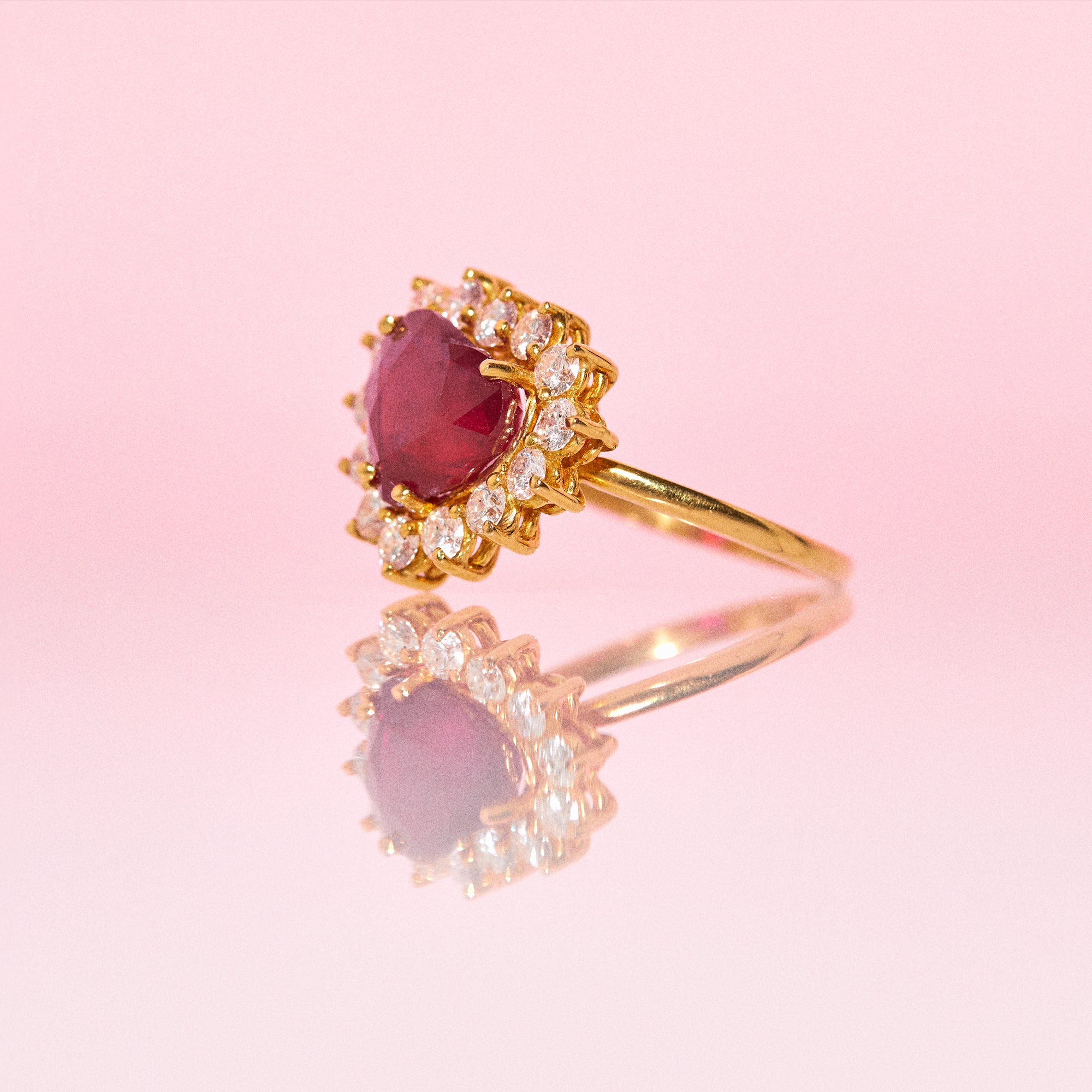 18ct gold ring set with a heart shaped ruby and diamonds