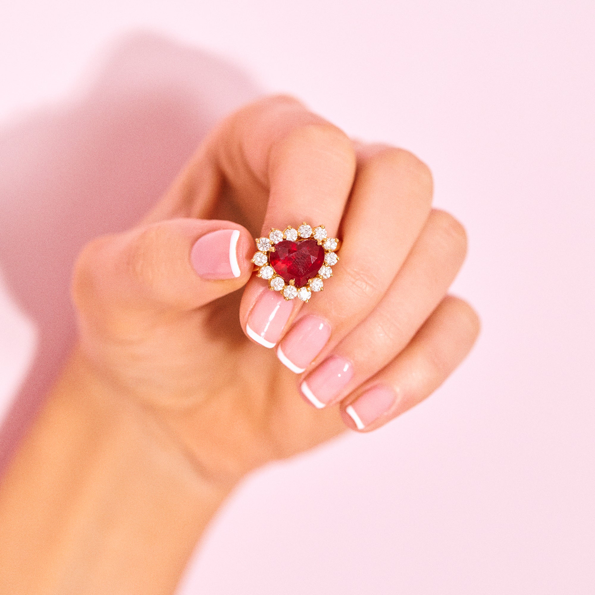 18ct gold ring set with a heart shaped ruby and diamonds