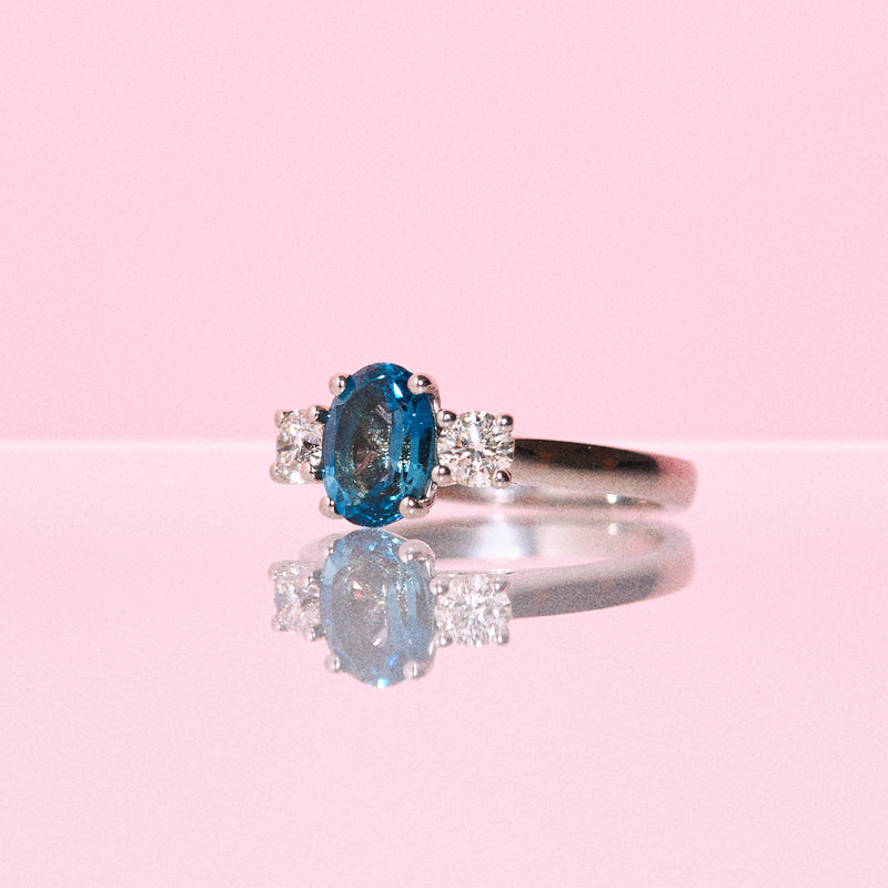 Platinum ring set with a blue topaz and a diamonds