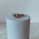 18ct gold love ring set with a ruby, a sapphire and diamonds