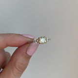 Platinum ring set with one, natural, yellow diamond and two white, pear shaped diamonds