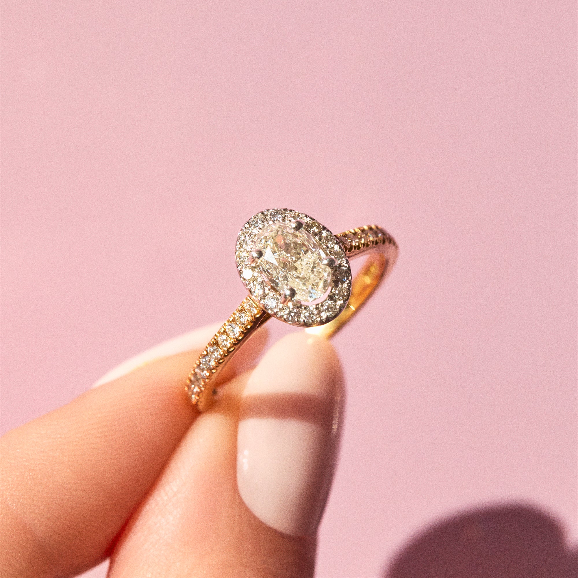 18ct gold ring set with a 1.01ct oval yellow diamond and a 0.38ct diamond halo