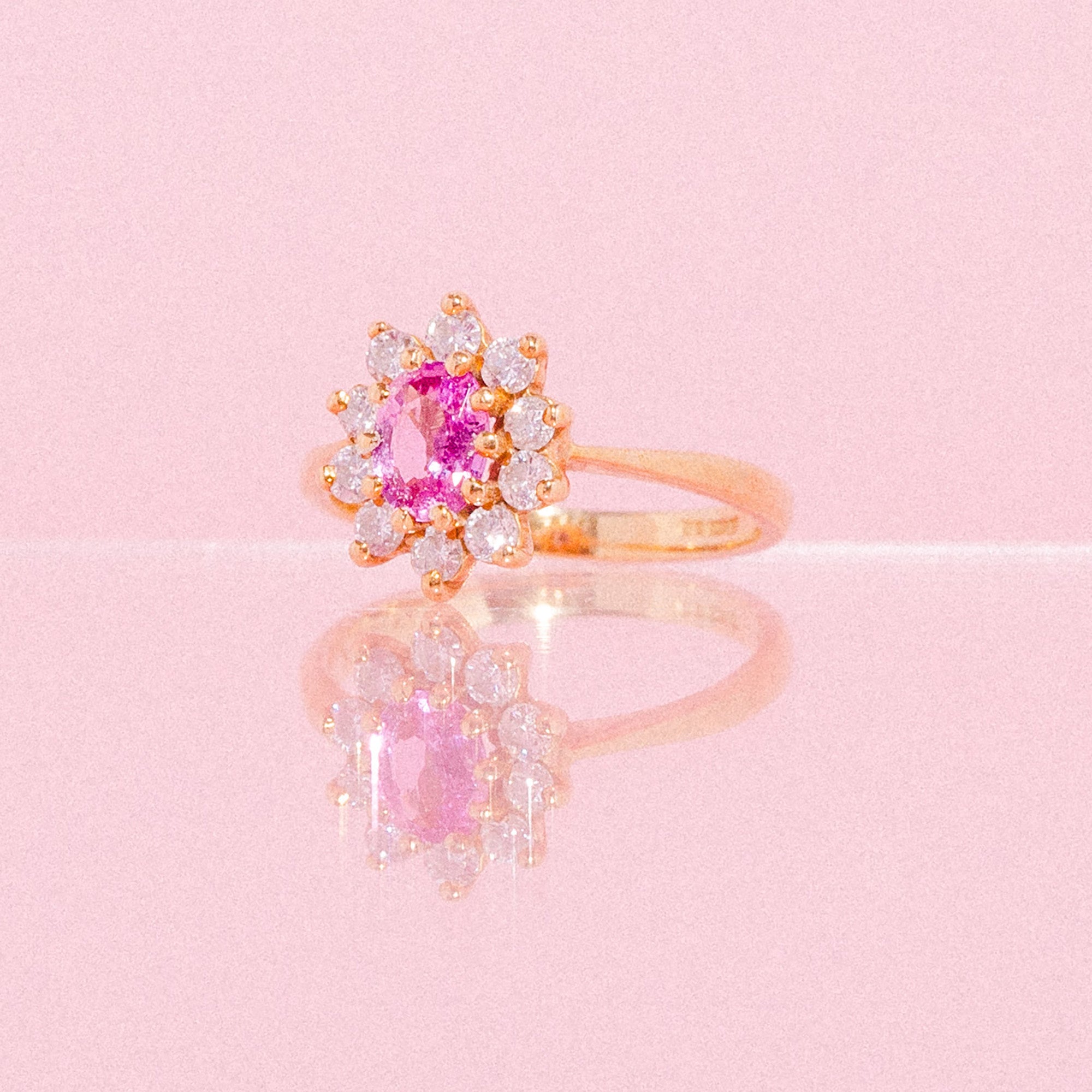 18ct gold ring set with a pink sapphire and diamonds