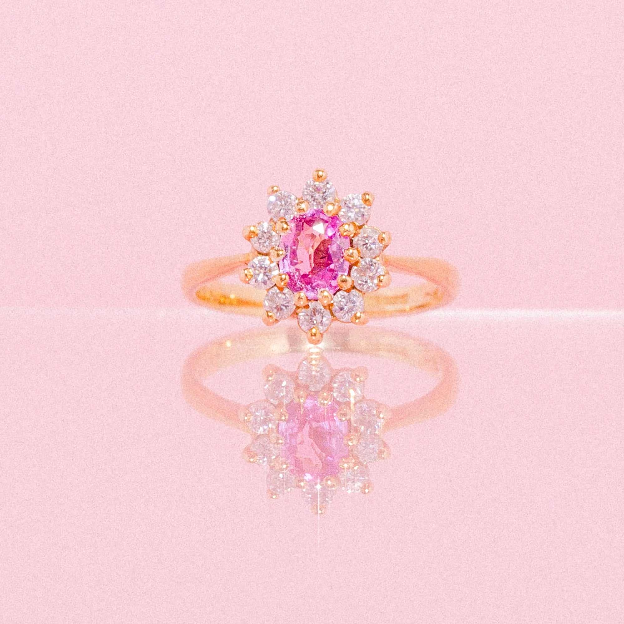 18ct gold ring set with a pink sapphire and diamonds