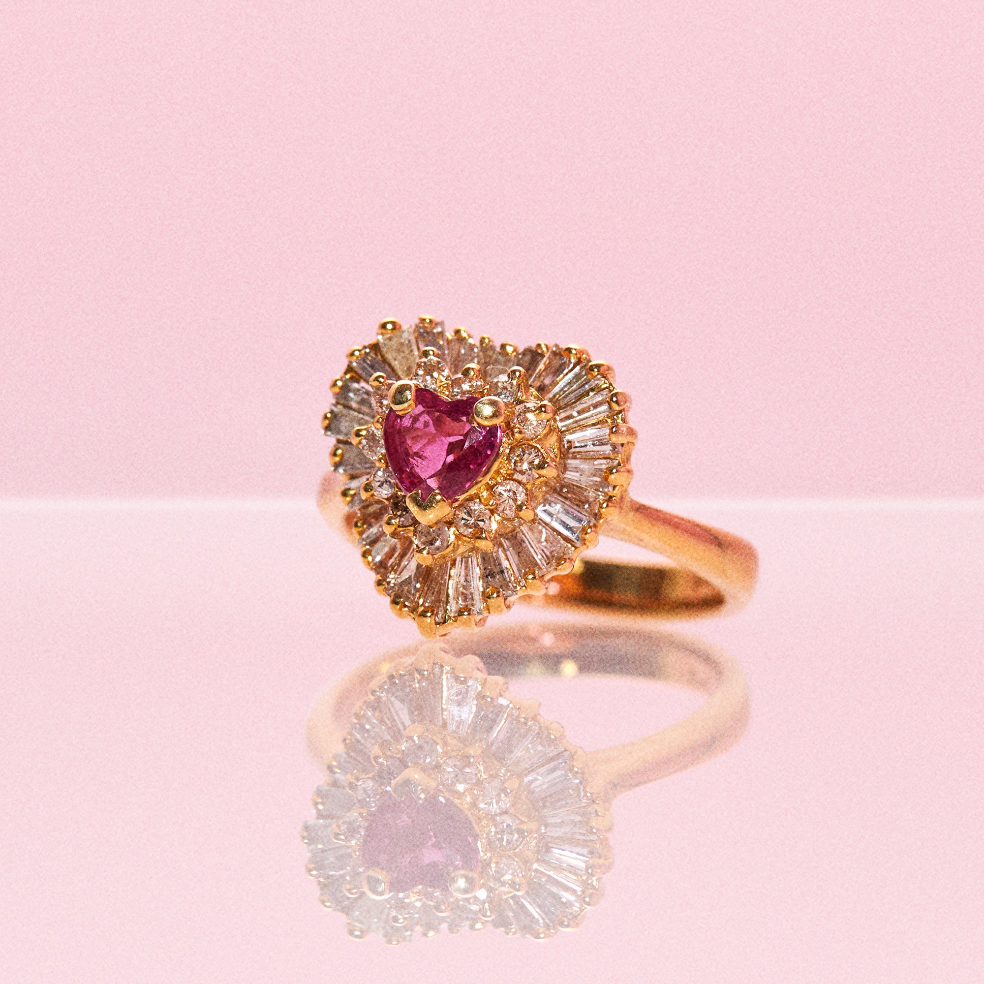 14ct gold ring set with a heart shaped ruby and diamonds