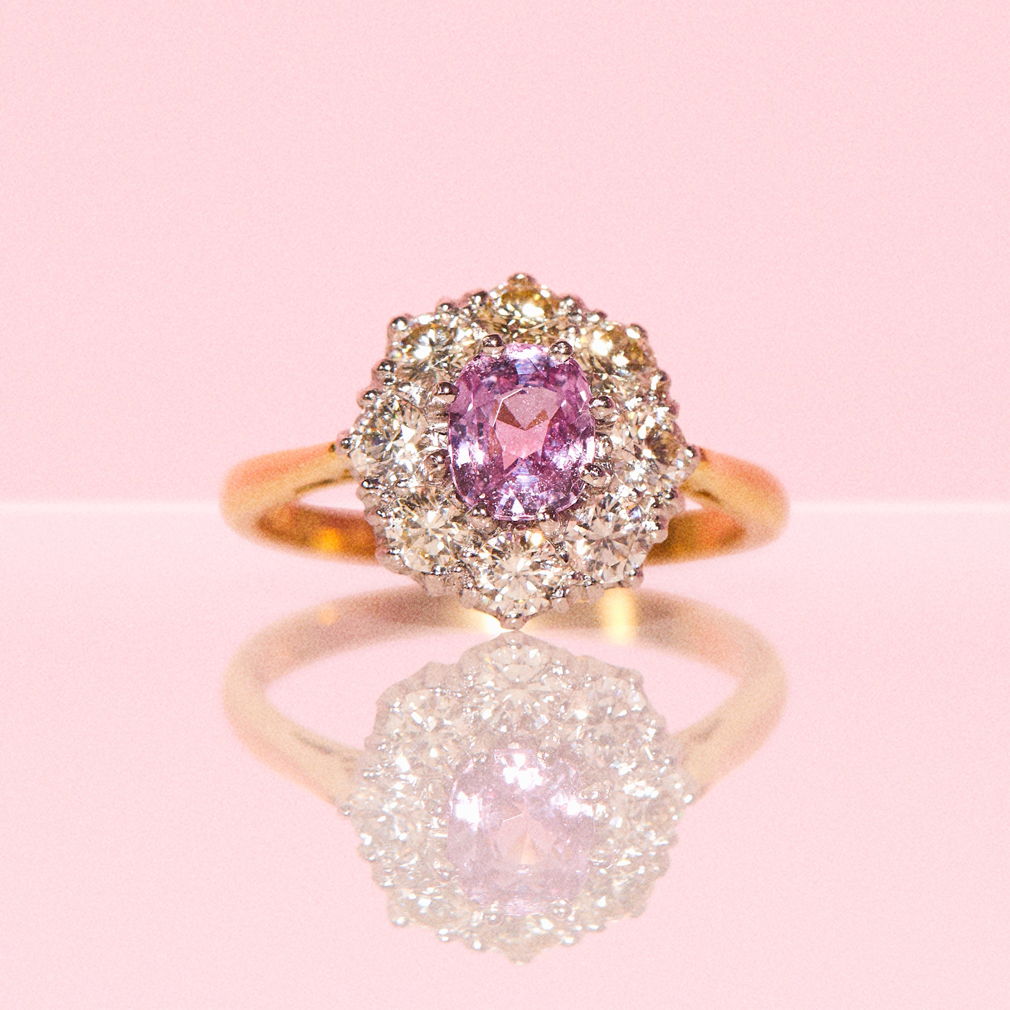 18ct gold ring set with a pink sapphire and diamonds