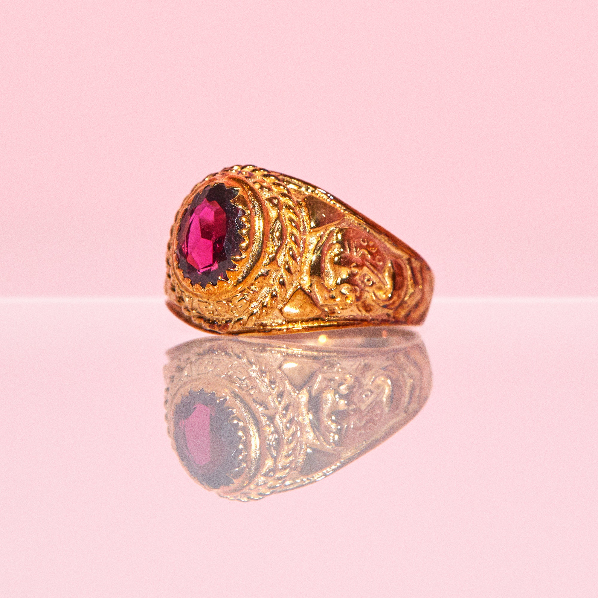 9ct gold ring set with a garnet an engraved head