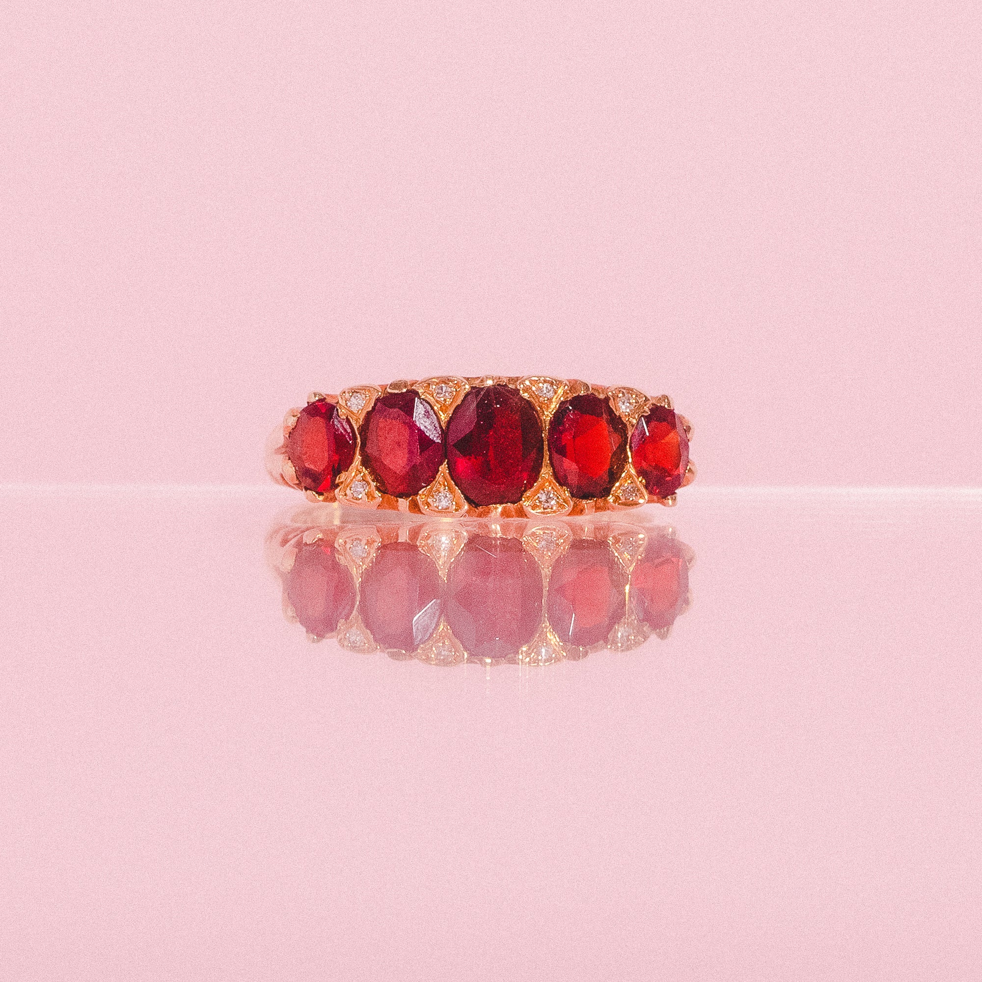 18ct gold carved ring with five garnets and diamonds