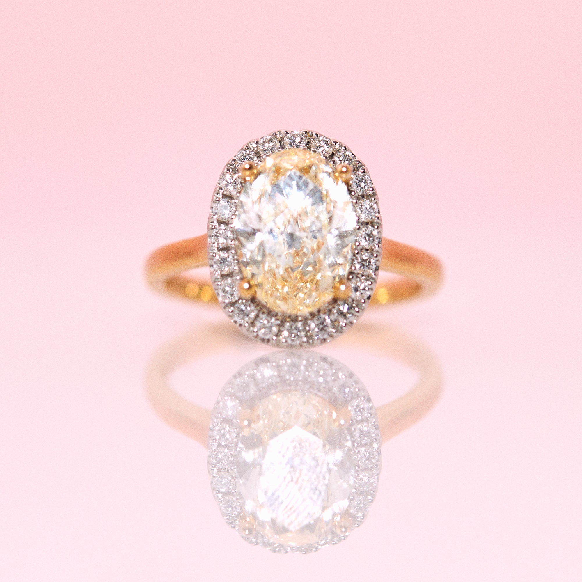 18ct gold yellow diamond ring with a diamond halo