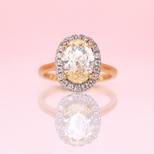 18ct gold yellow diamond ring with a diamond halo