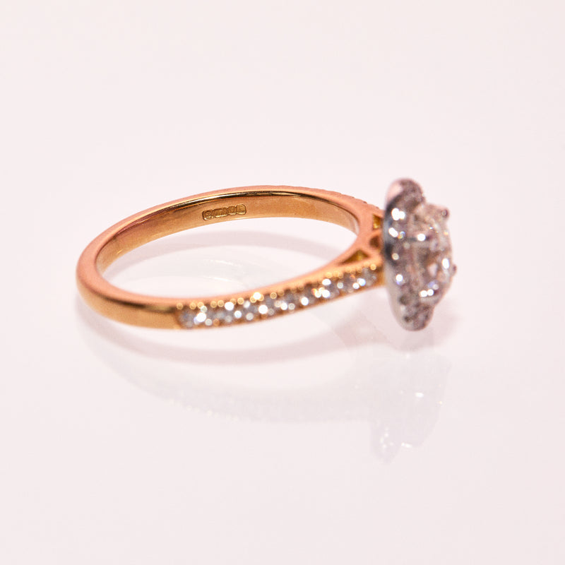 18ct gold ring set with a 1.01ct oval yellow diamond and a 0.38ct diamond halo