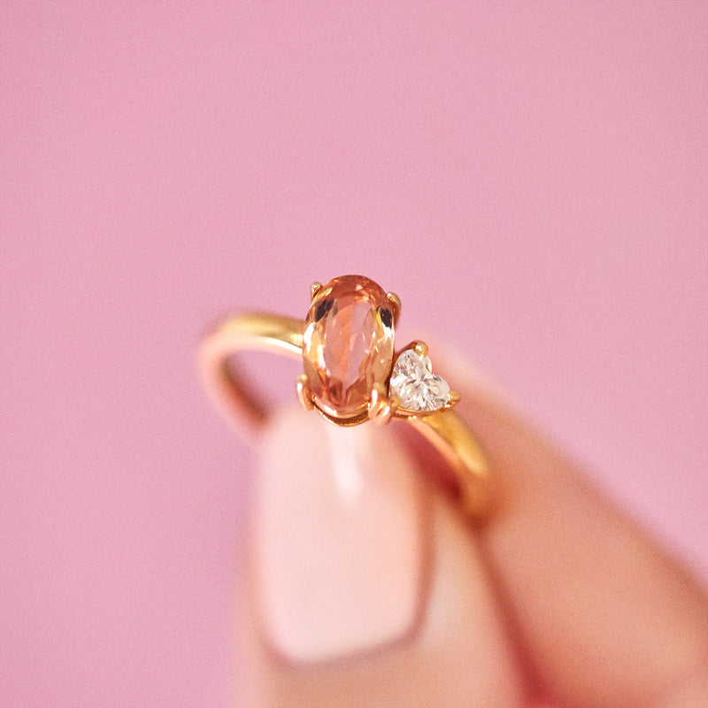 18ct gold ring set with a peach topaz and a heart shaped diamond