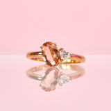 18ct gold ring set with a peach topaz and a heart shaped diamond