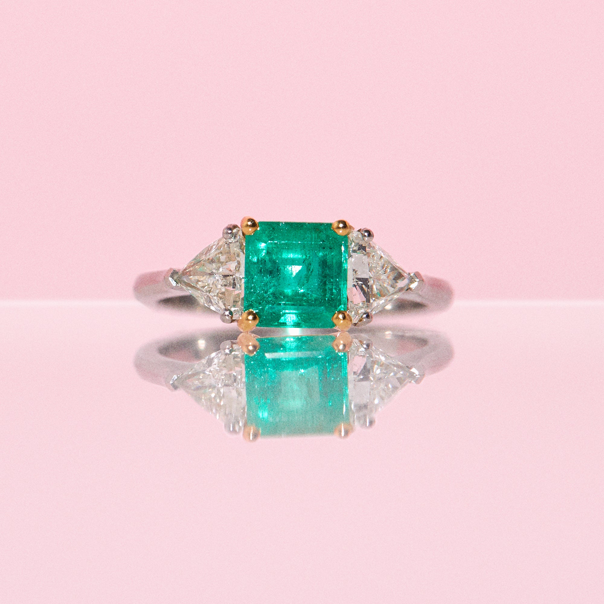 Platinum emerald and diamond three stone ring