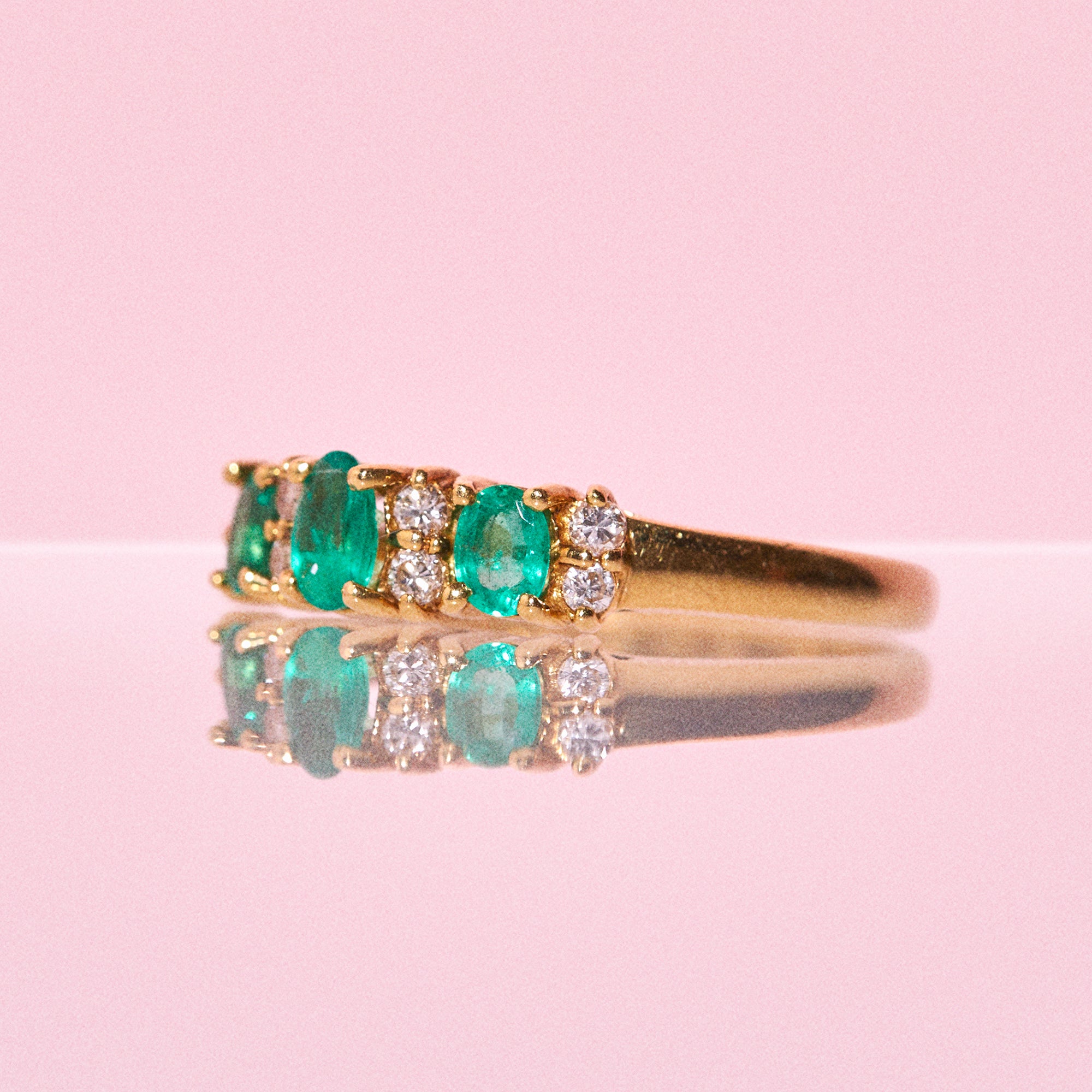 18ct gold ring set with emeralds and diamonds