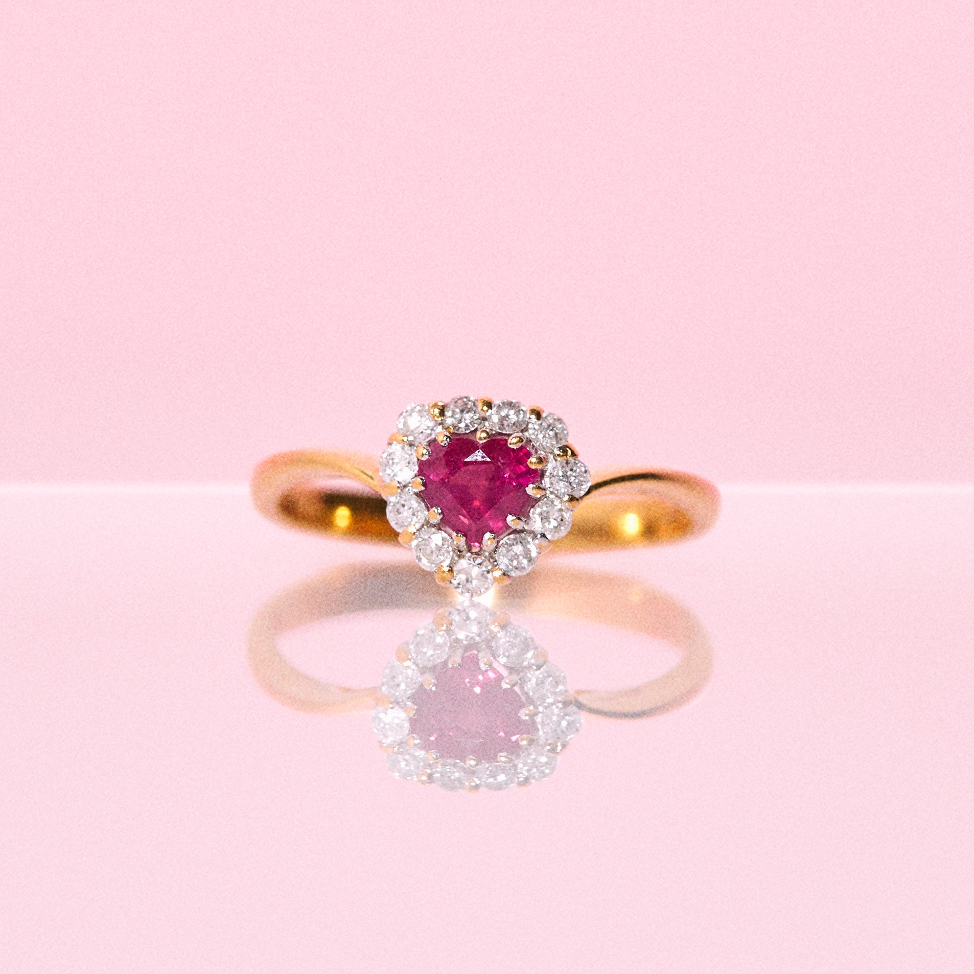 18ct gold ring set with a heart shaped ruby and diamonds