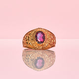 9ct gold ring set with a garnet an engraved head