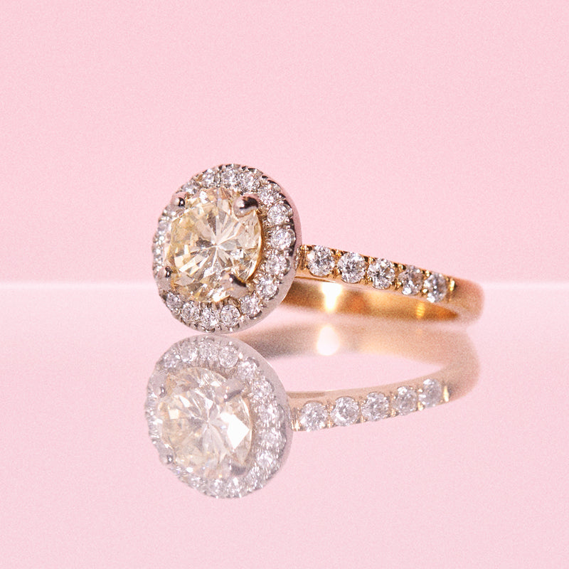 18ct yellow gold yellow diamond ring set with a diamond halo