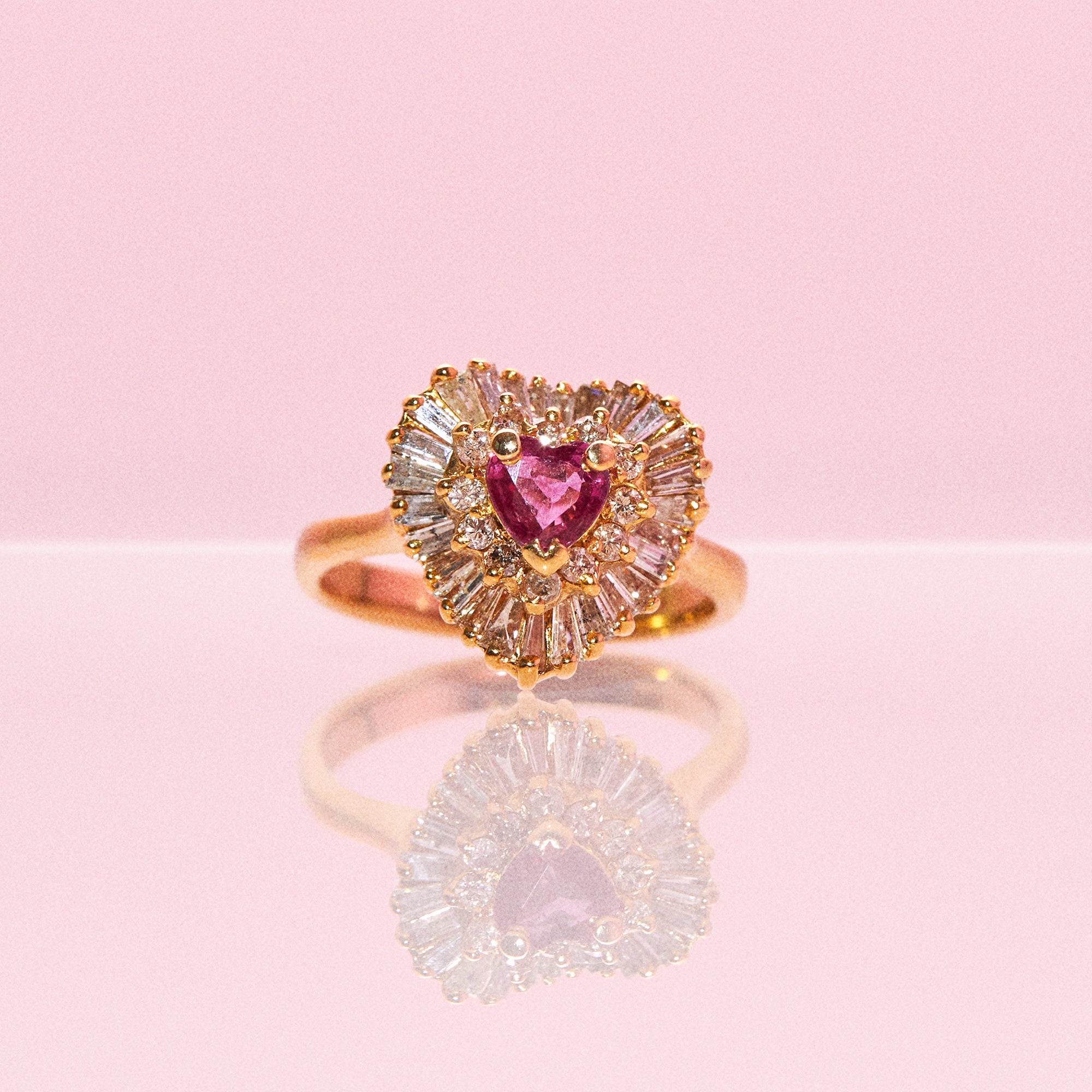 14ct gold ring set with a heart shaped ruby and diamonds