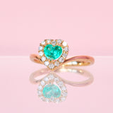 14ct gold ring set with a heart shaped emerald and diamonds