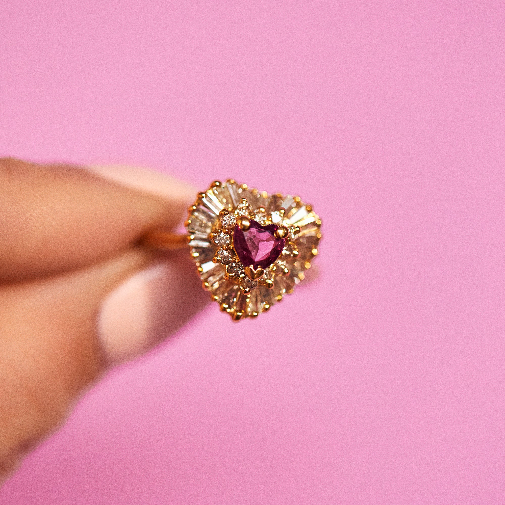 14ct gold ring set with a heart shaped ruby and diamonds